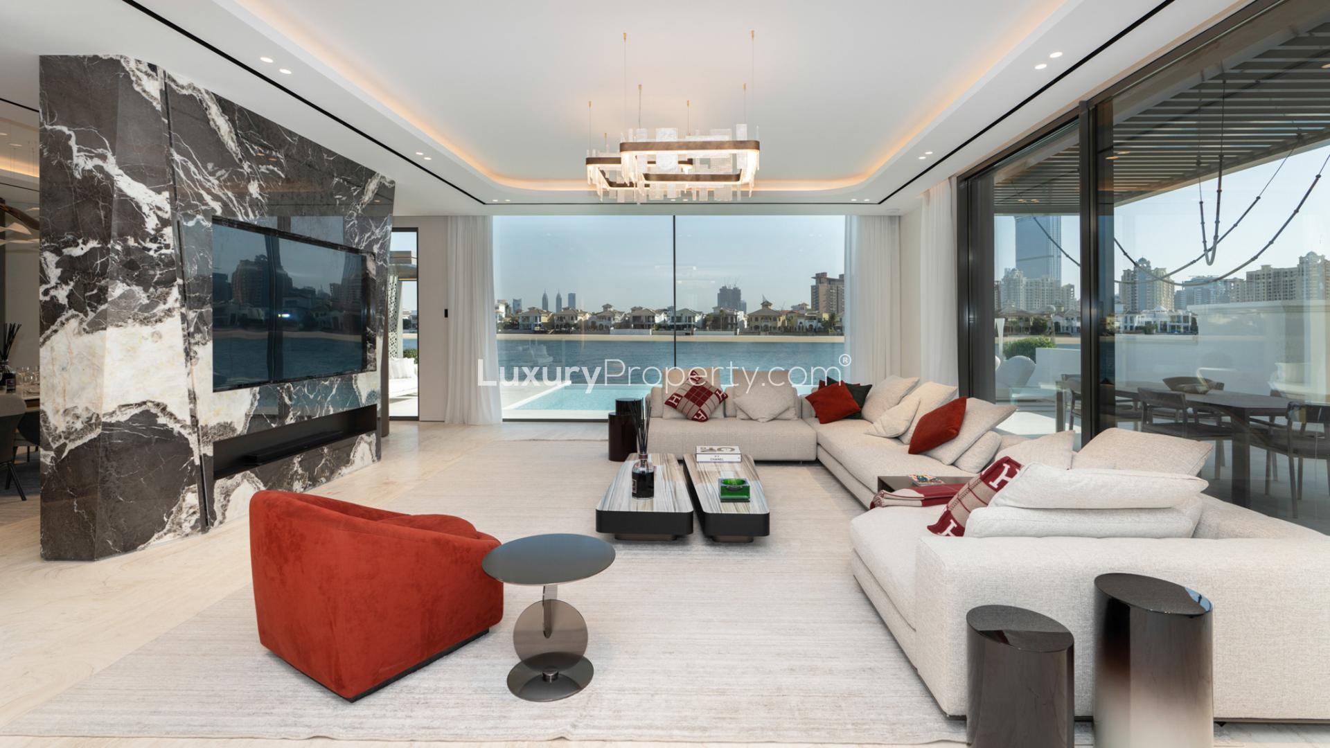 "Stunning Palm Jumeirah villa exterior with pool, modern design, and luxurious seating area.",Luxurious Palm Jumeirah villa living room with stunning waterfront views, modern decor, spacious layout