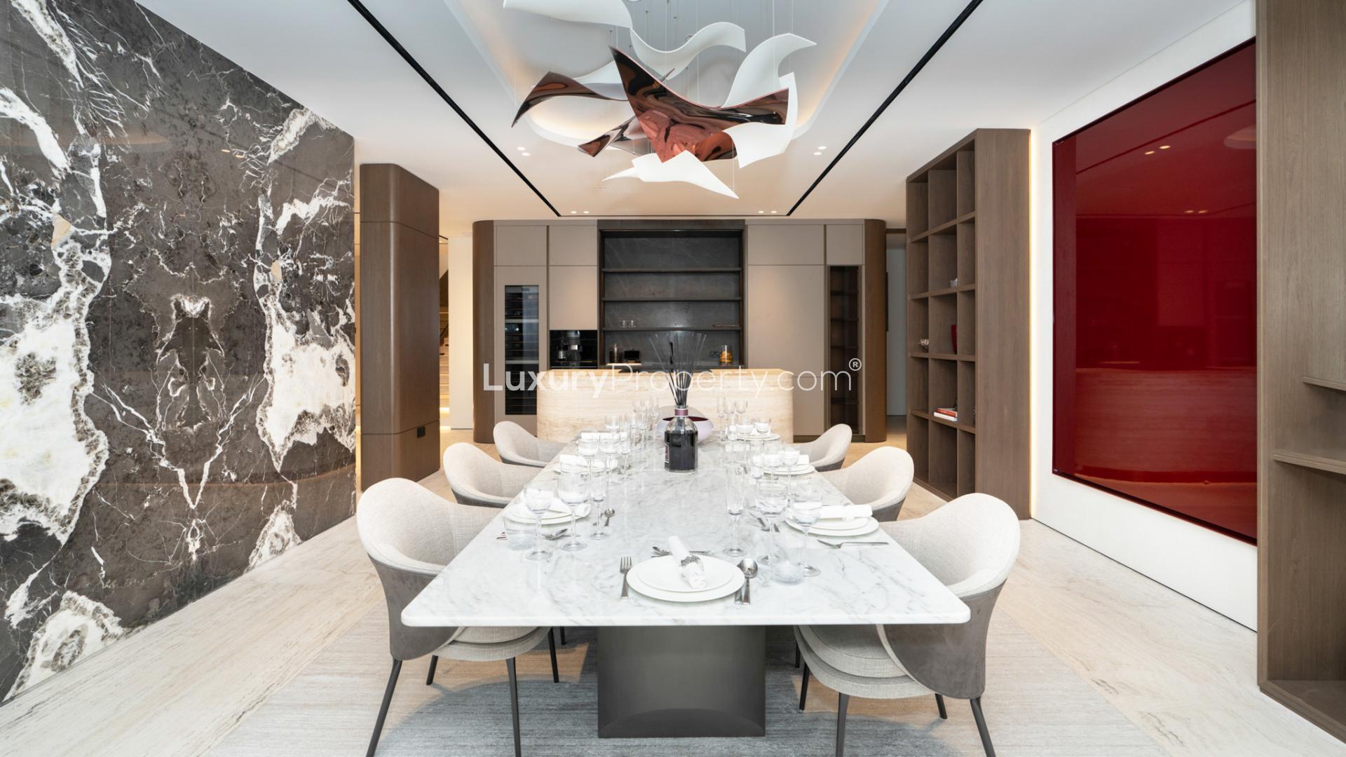 Elegant dining area in upgraded Palm Jumeirah villa, featuring modern decor and marble table