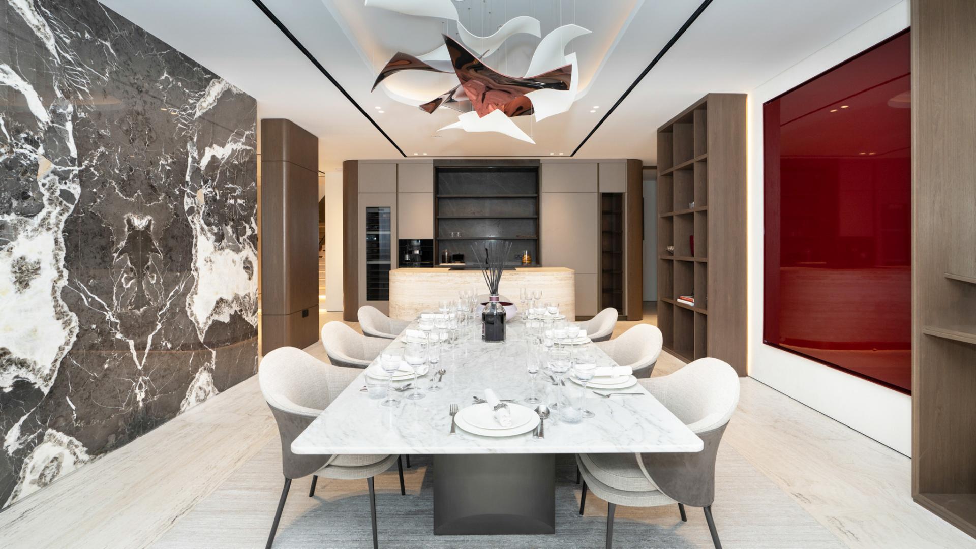 Elegant dining area in upgraded Palm Jumeirah villa, featuring modern decor and marble table