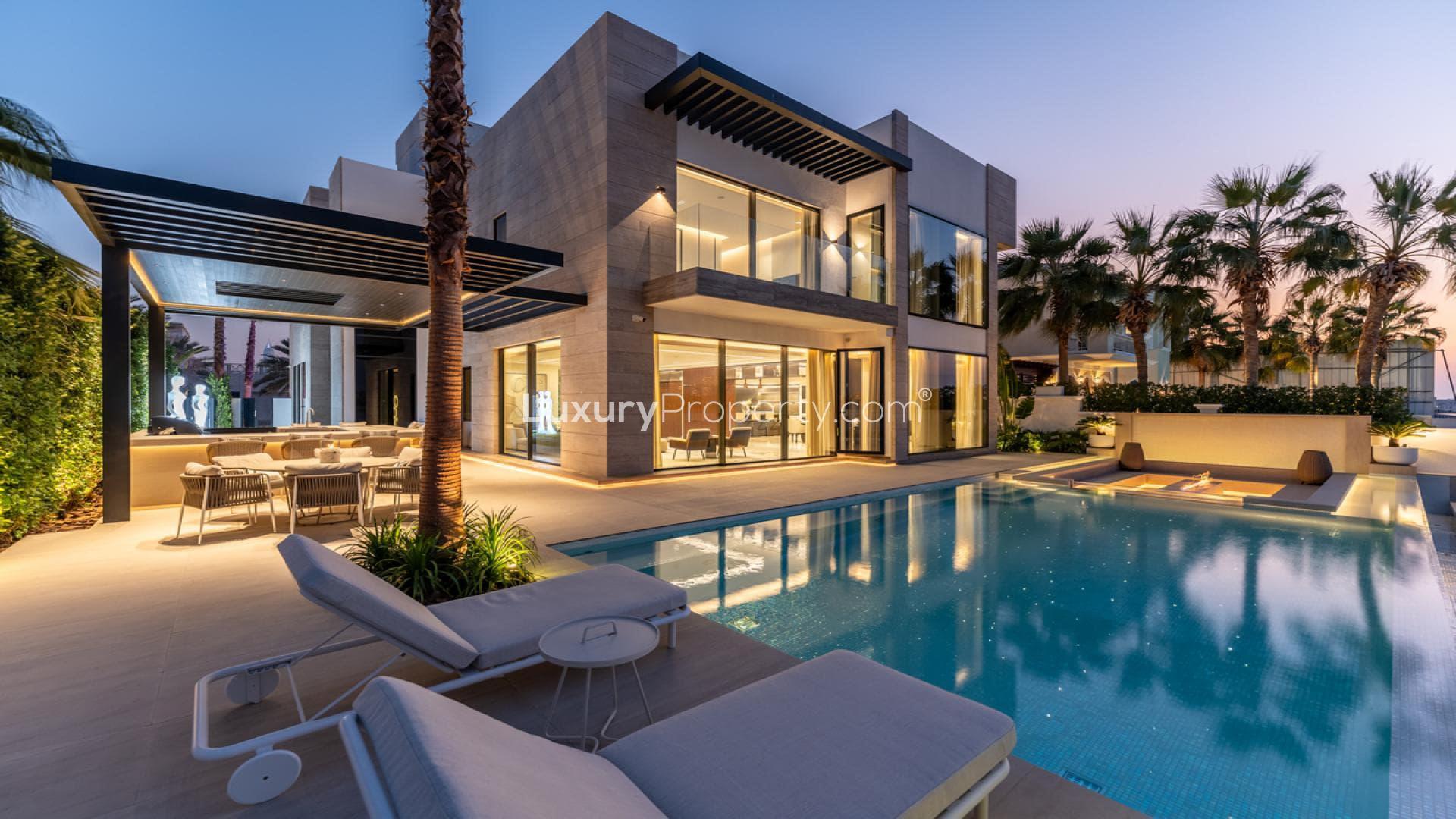 Luxury villa with illuminated pool and modern patio in Palm Jumeirah, Garden Homes
