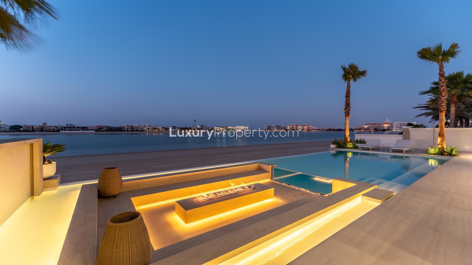 Luxury villa with illuminated pool and modern patio in Palm Jumeirah, Garden Homes