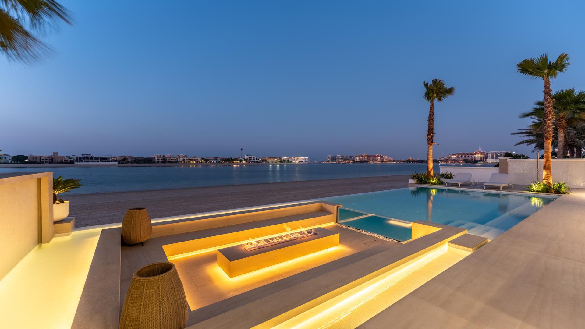 Luxury villa with illuminated pool and modern patio in Palm Jumeirah, Garden Homes