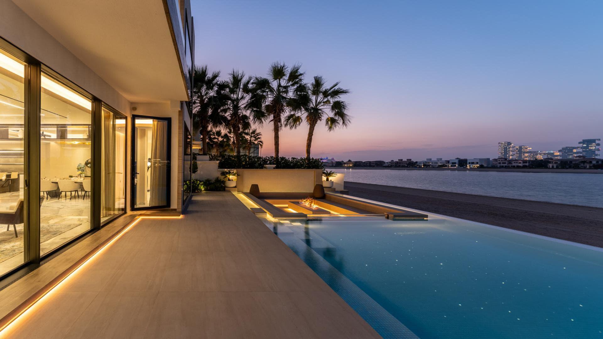 Luxury Palm Jumeirah villa pool with serene sea views at sunset, Garden Homes community