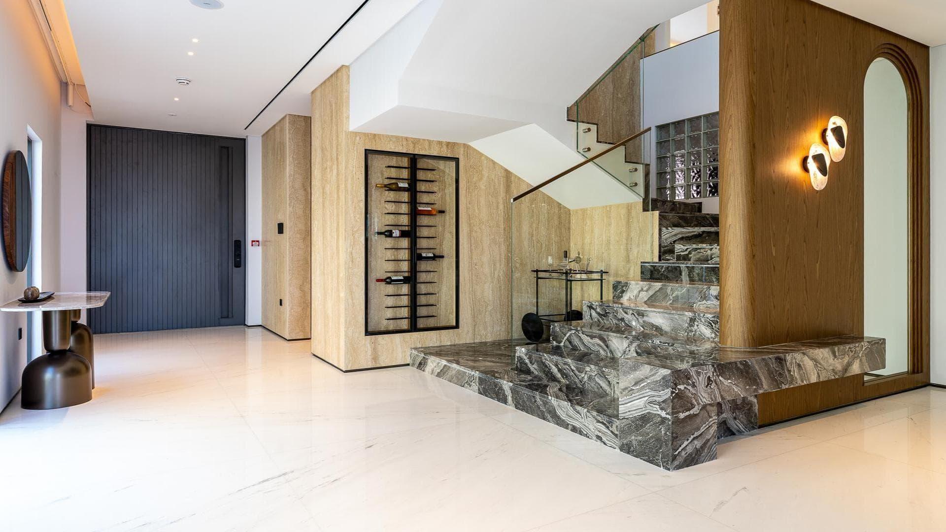 Modern villa exterior with luxury car, Palm Jumeirah, Garden Homes. 5-bed, 7-bath for sale