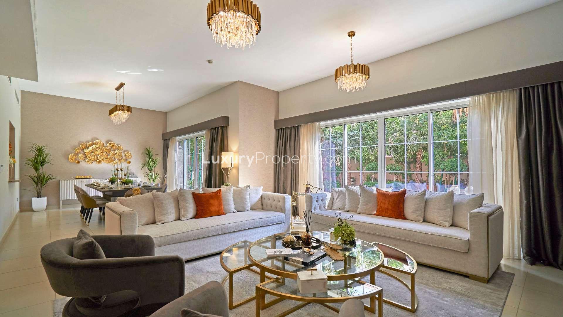 Elegant dining room in Nad Al Sheba 1 villa, featuring modern decor and garden view