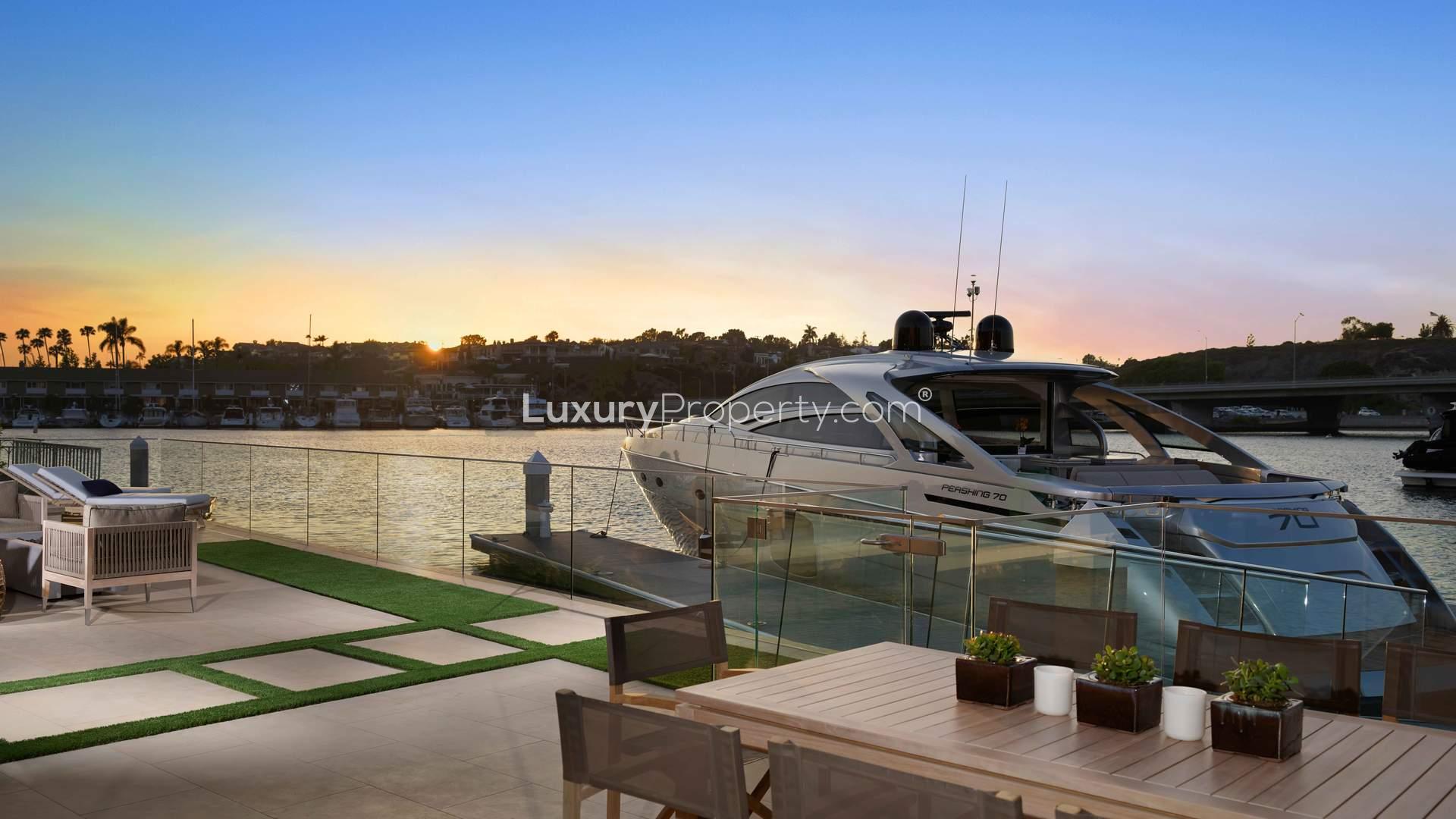 Modern Newport Beach villa with marina berth, waterfront view, and elegant architecture at sunset