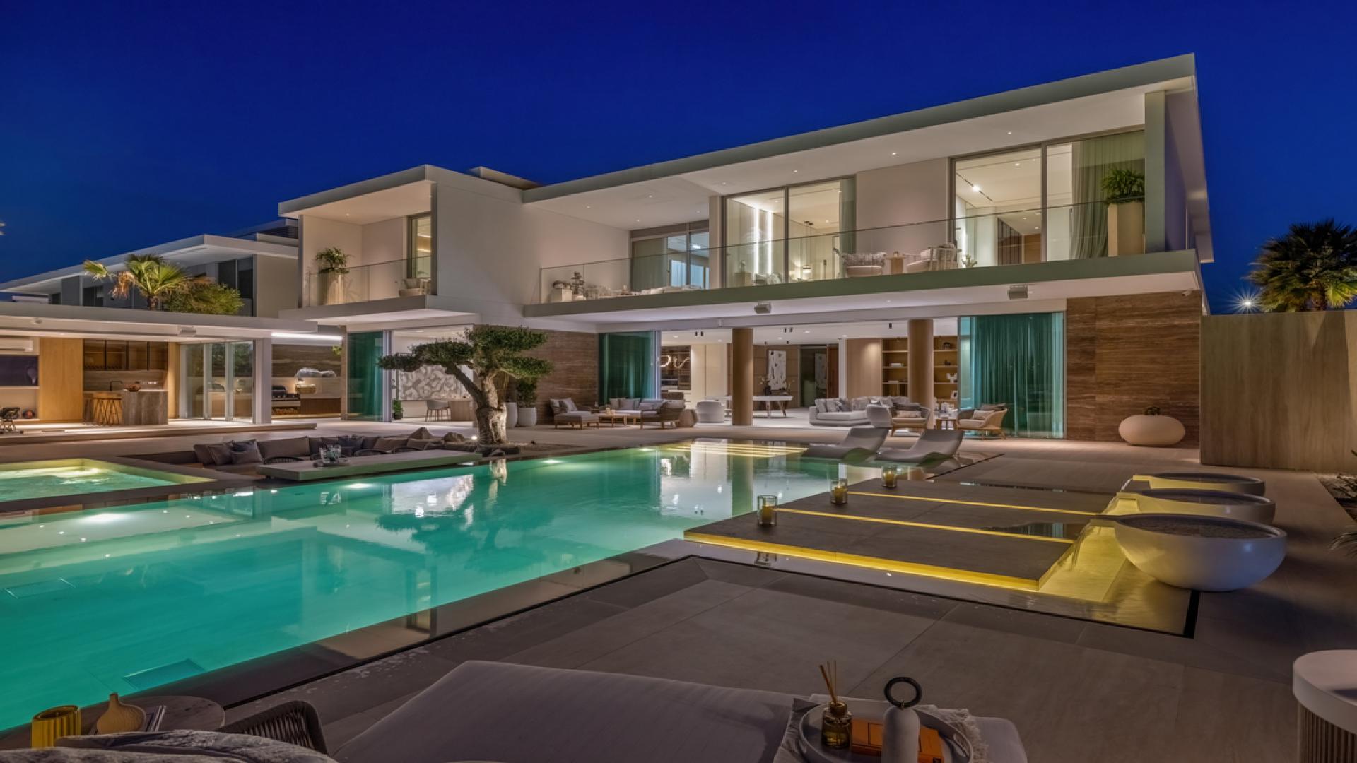 "Luxurious outdoor living space at 5-bedroom villa in Dubai Hills Estate, featuring modern amenities.",Ultra-luxury villa with pool at night, Dubai Hills Estate, ideal family home