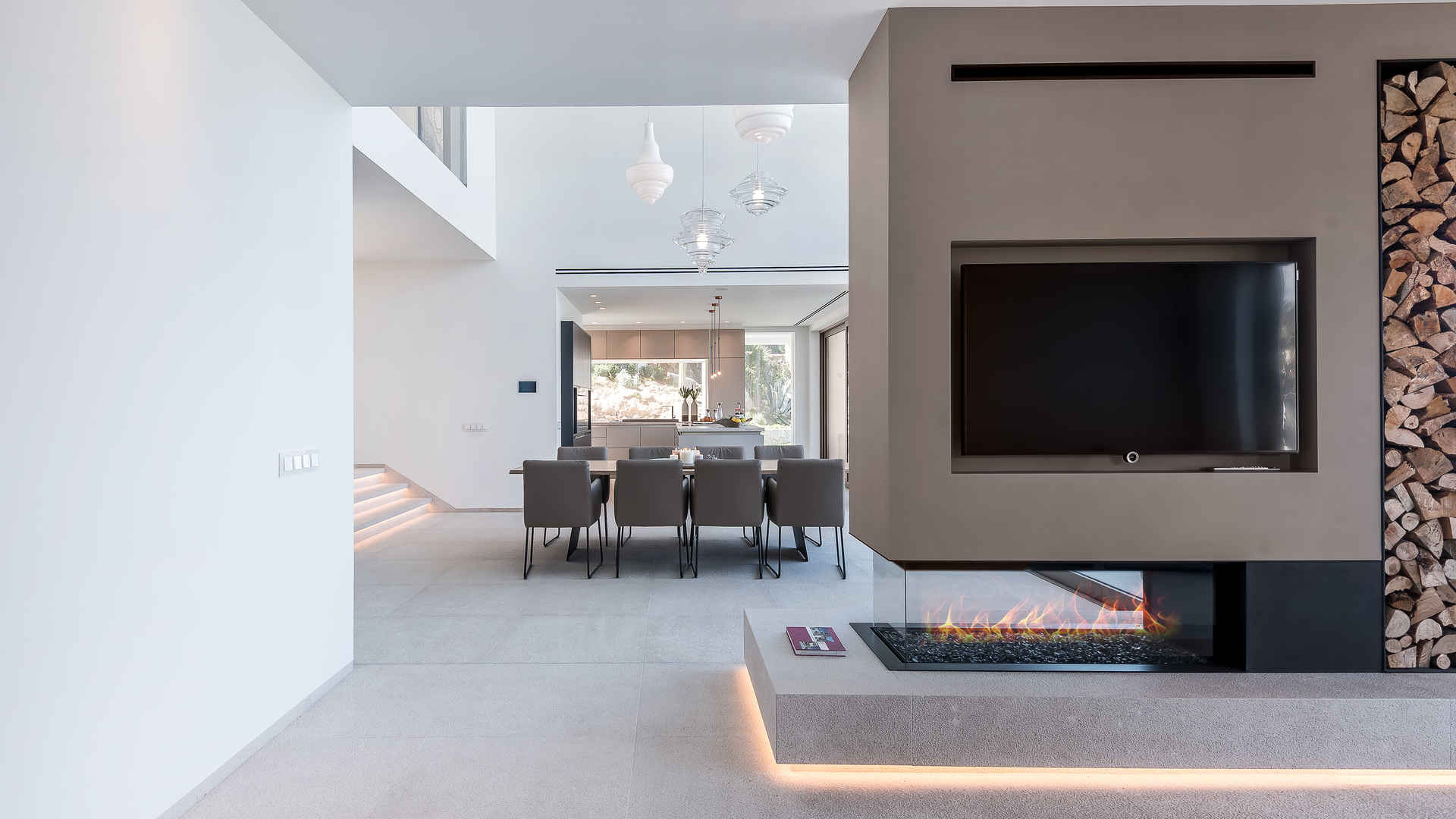 Contemporary living room in Mallorca villa, featuring modern fireplace and elegant decor