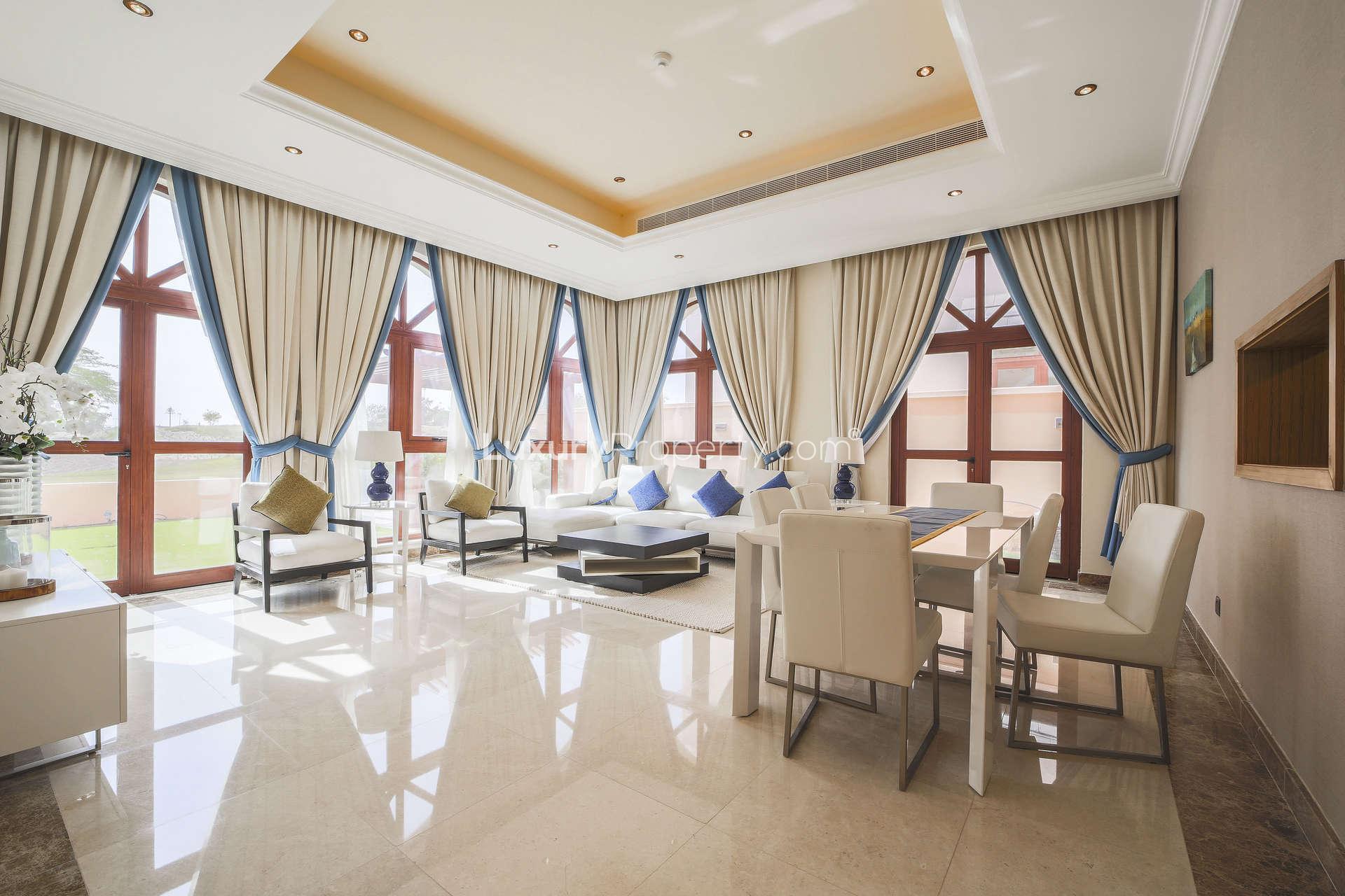Luxurious bedroom in Jumeirah Golf Estates villa with elegant decor and large windows