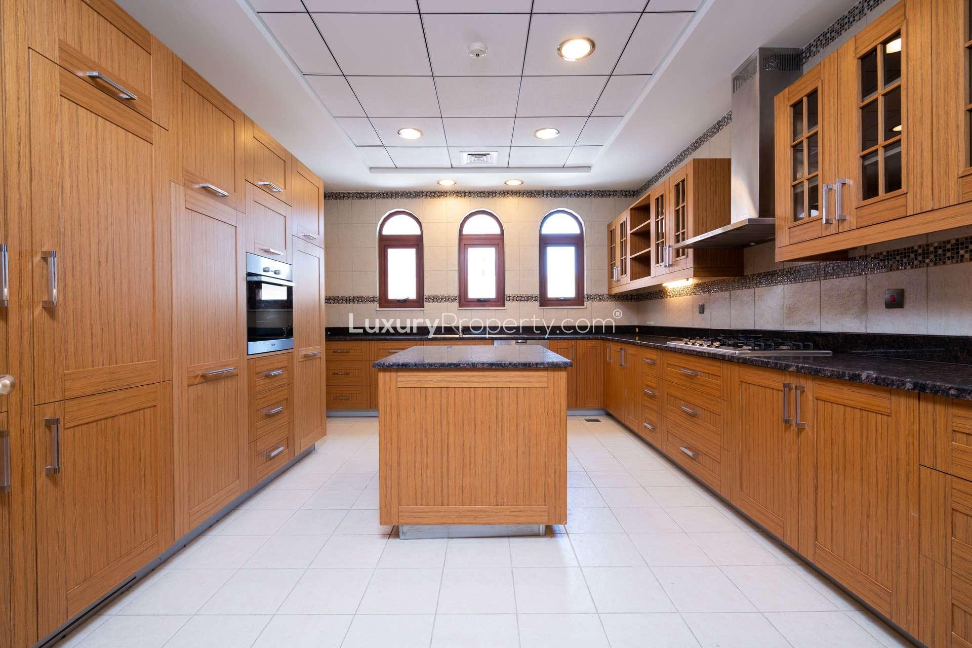 Empty room with wooden floor and large window in Jumeirah Golf Estates villa