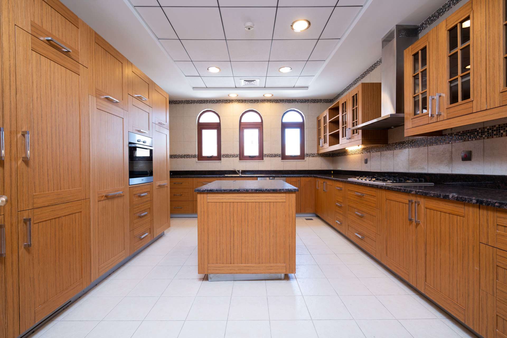 Empty room with wooden floor and large window in Jumeirah Golf Estates villa