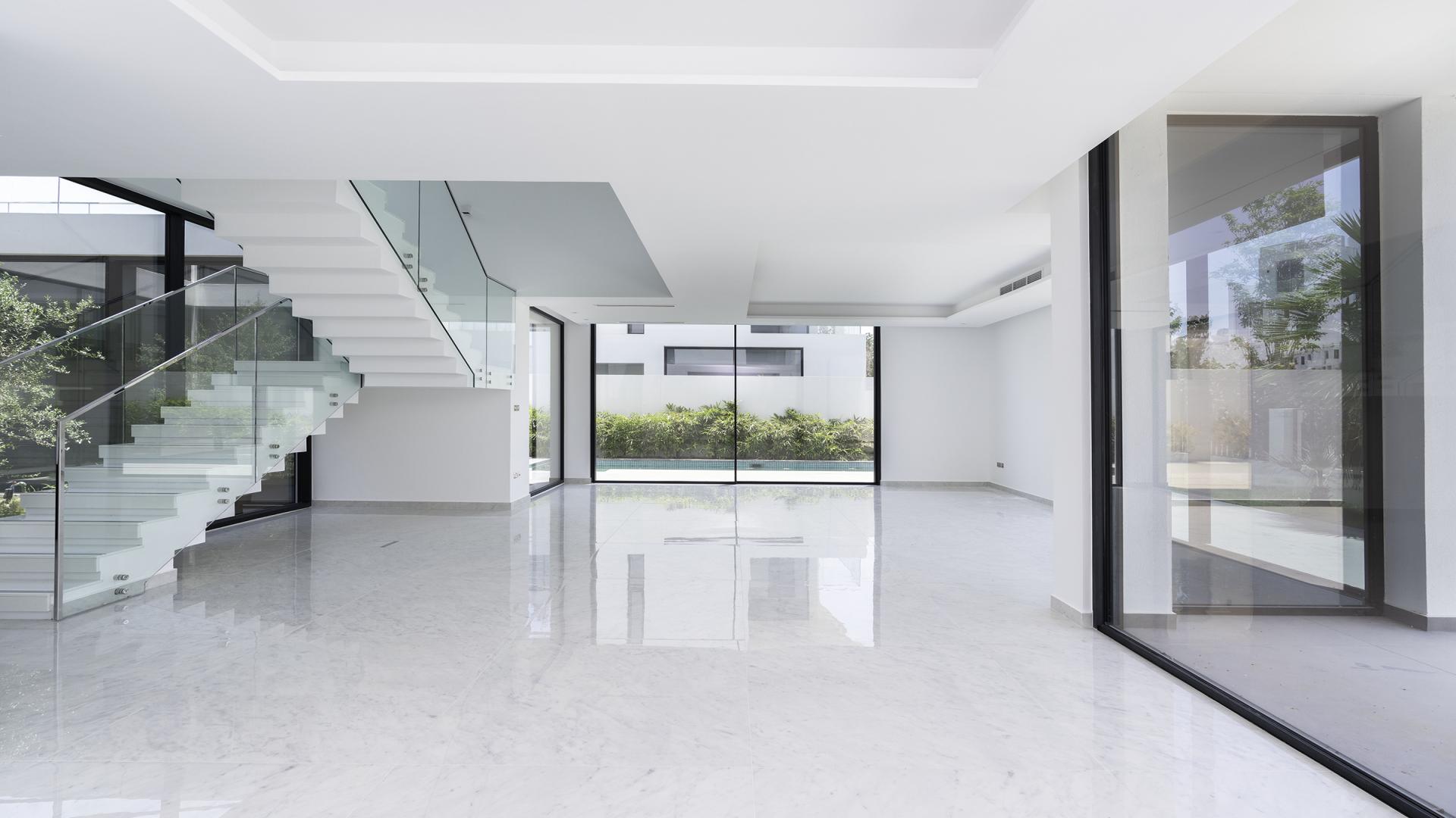 Spacious living room with large windows in Al Barari Chorisia 2 Villa for sale