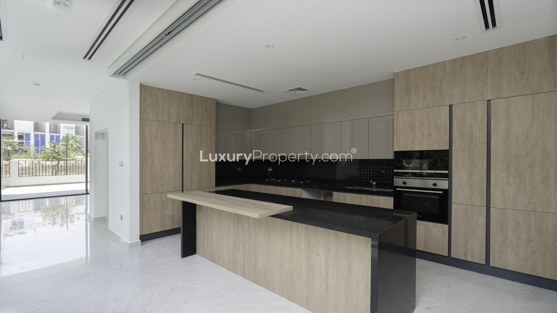 Modern open-plan interior with glass staircase in Chorisia 2 Villa, Al Barari