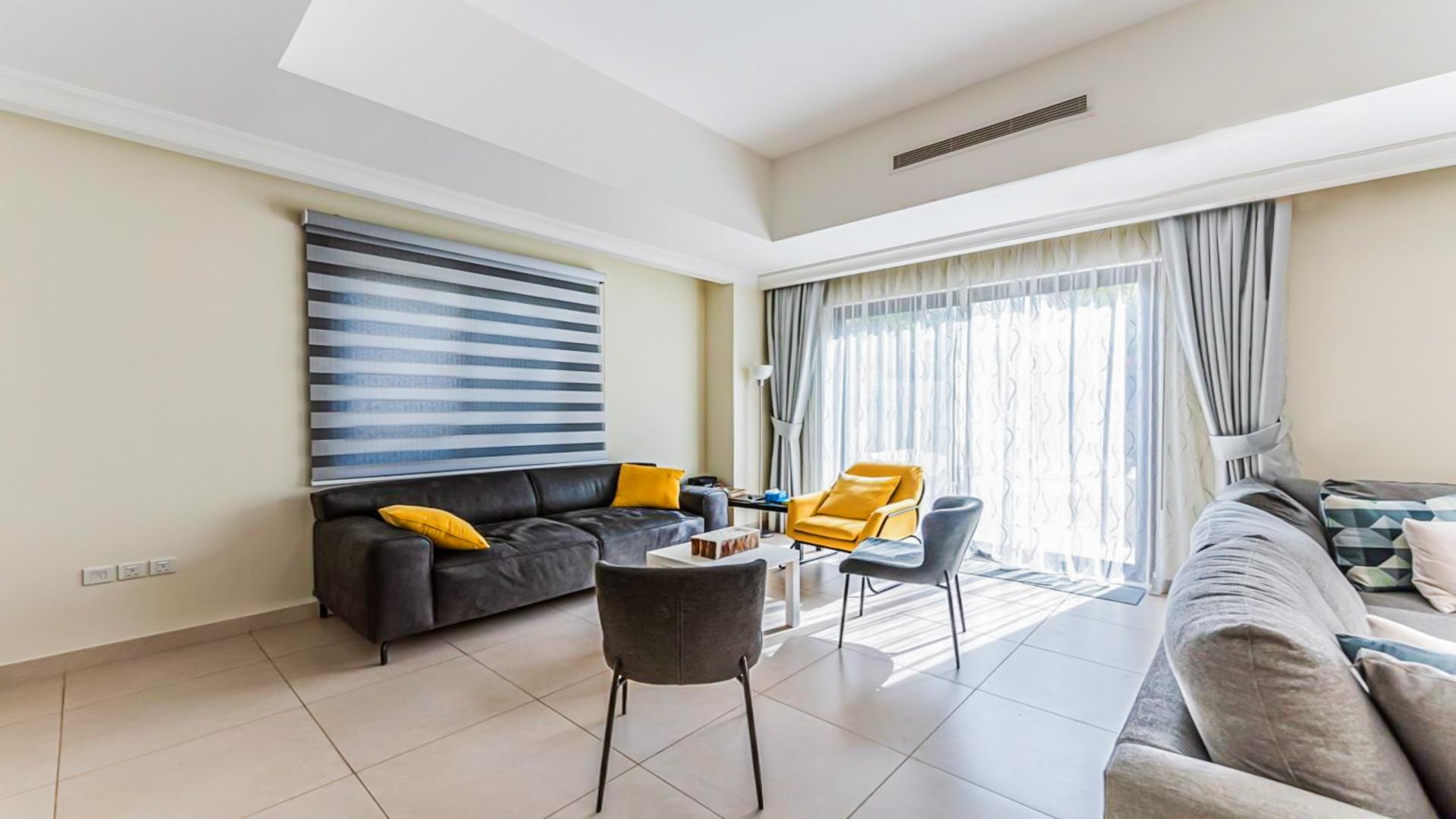 Spacious living room in Palma villa, Arabian Ranches 2, with modern decor and play area