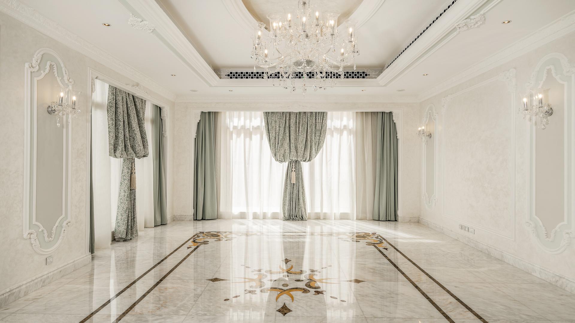 Elegant living room in luxury Pearl Jumeirah villa with marble floors and chandelier