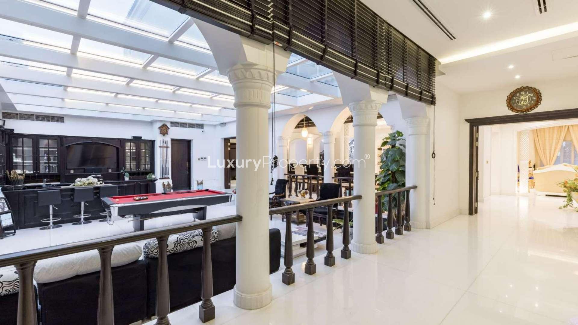 Luxurious interior of 5-bedroom villa in Arabian Ranches, featuring elegant columns and pool table