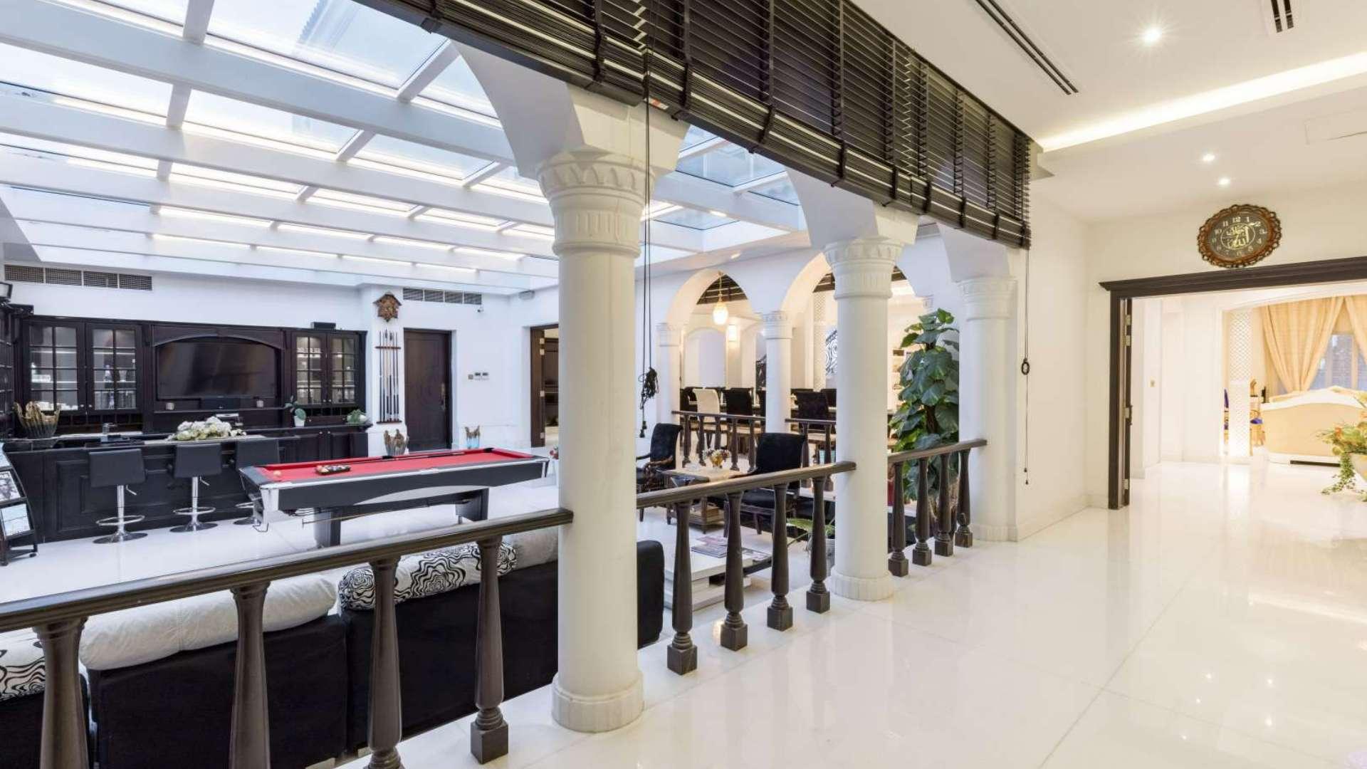 Luxurious interior of 5-bedroom villa in Arabian Ranches, featuring elegant columns and pool table