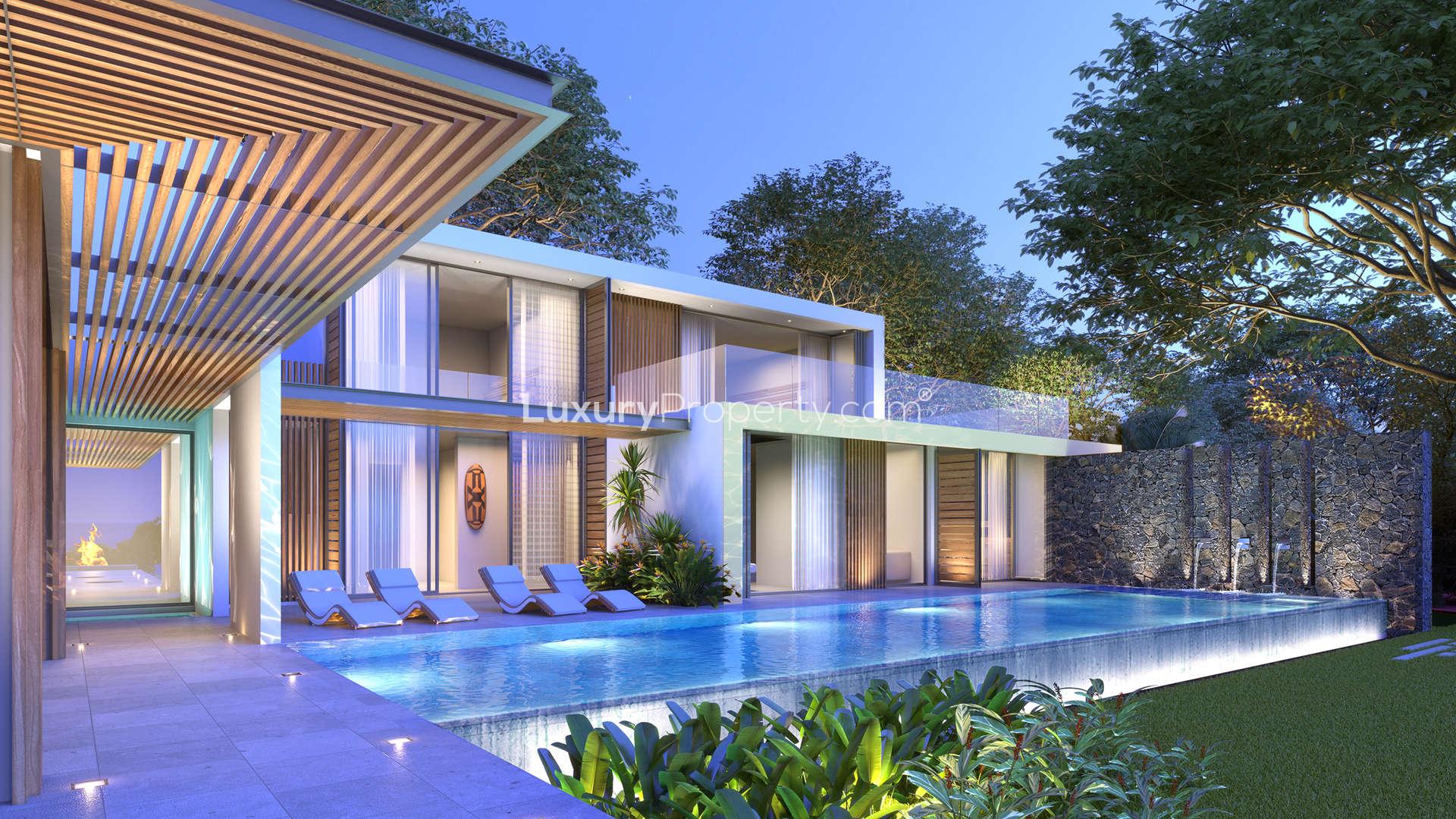 Luxurious open-plan villa living area with pool and ocean view at Anahita Mauritius Resort