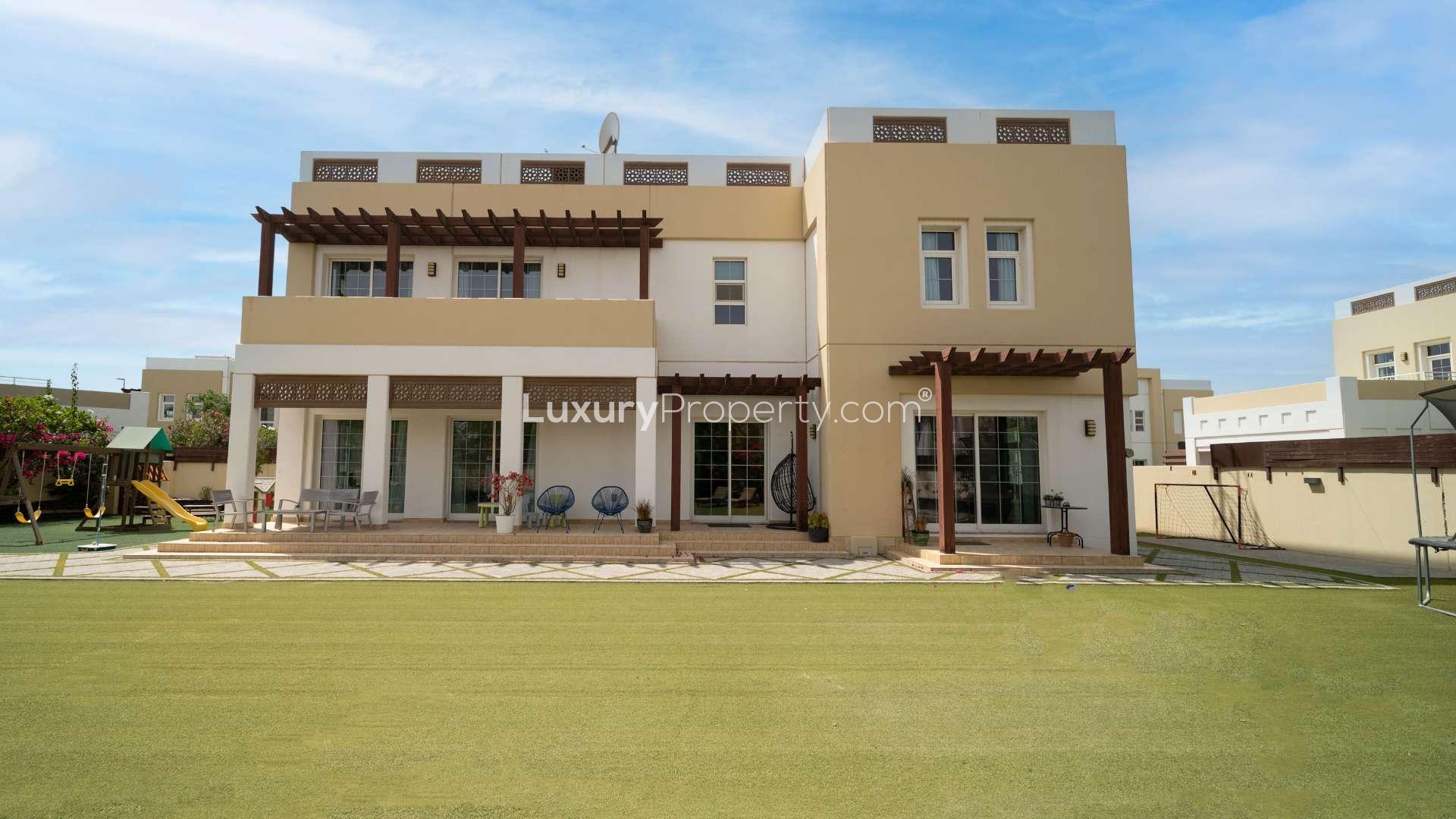 Luxurious 5-bedroom villa exterior with garden in Rahat, Mudon community, for sale