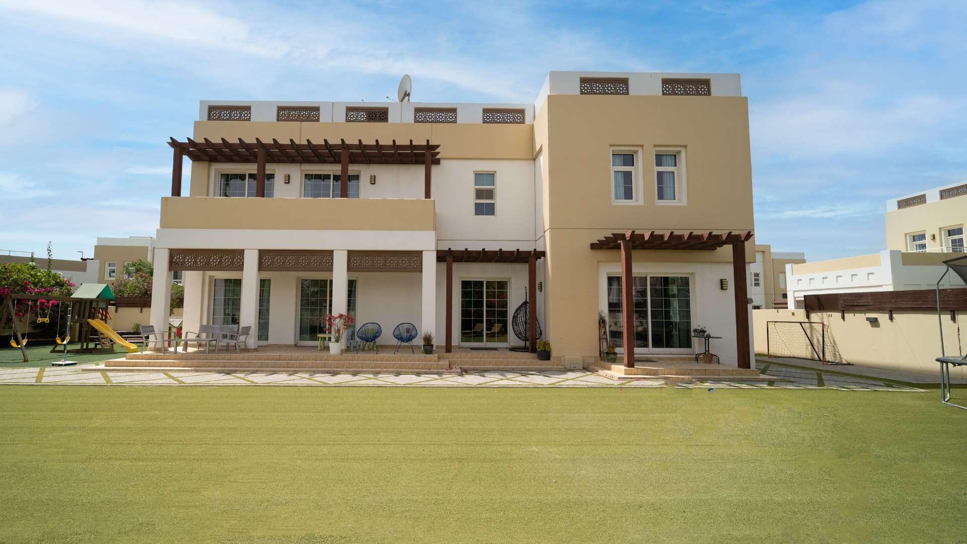 Luxurious 5-bedroom villa exterior with garden in Rahat, Mudon community, for sale