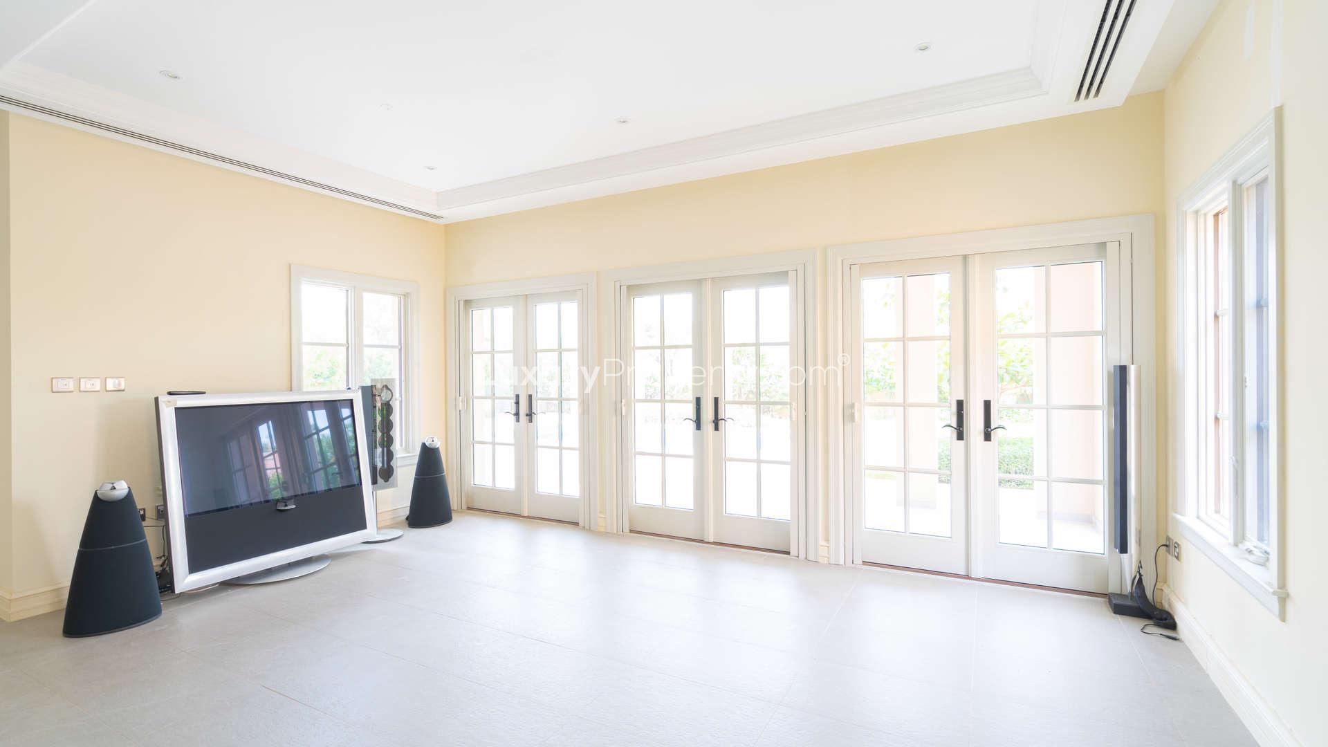 Luxurious villa living room with large windows, Jumeirah Golf Estates, for sale