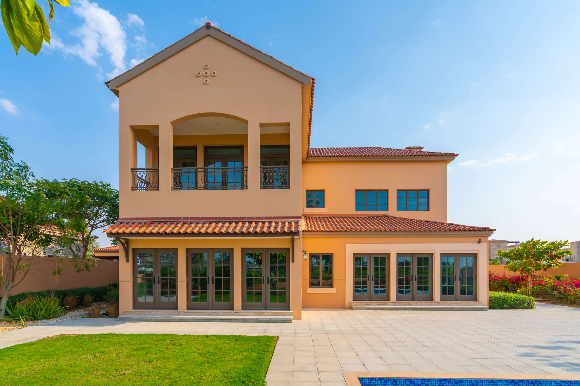 Spacious interior of Mediterranean villa in Jumeirah Golf Estates, featuring large windows and archway