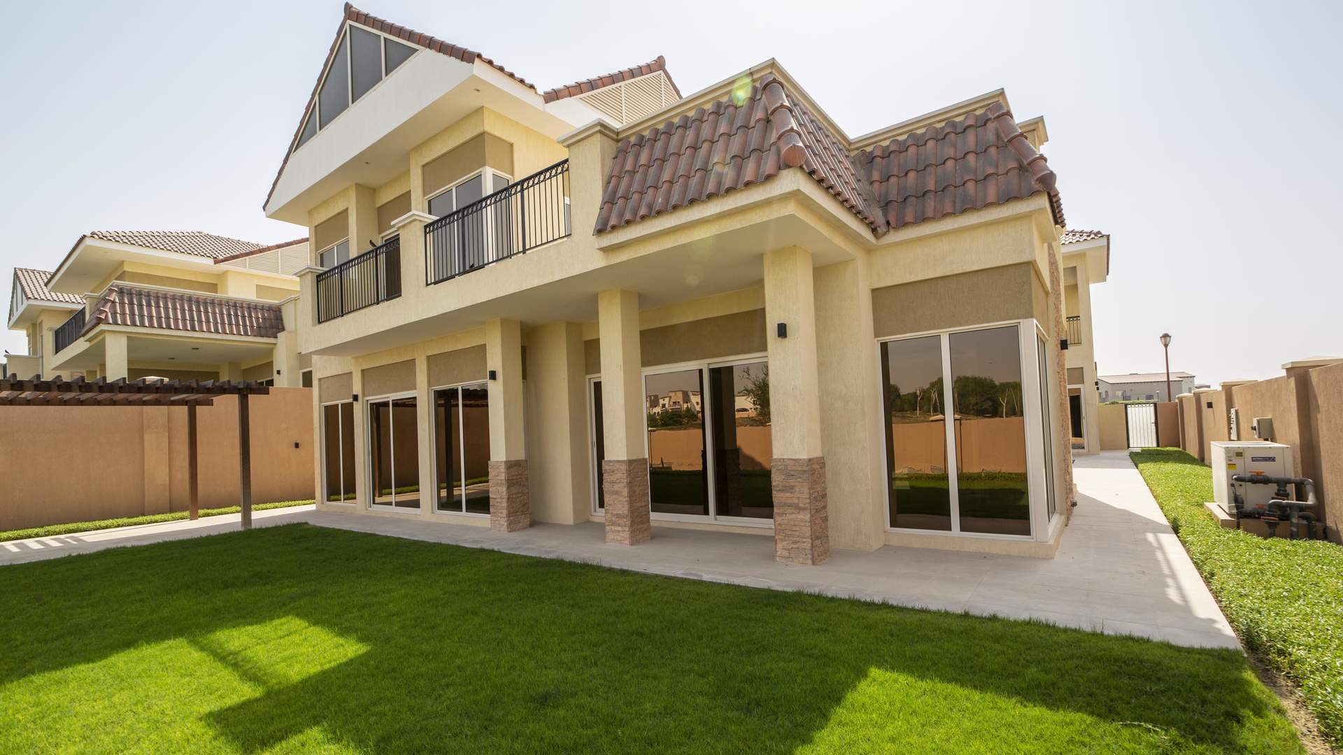 Luxurious five-bedroom villa exterior with lush lawn, Jumeirah Golf Estates, Sienna Views