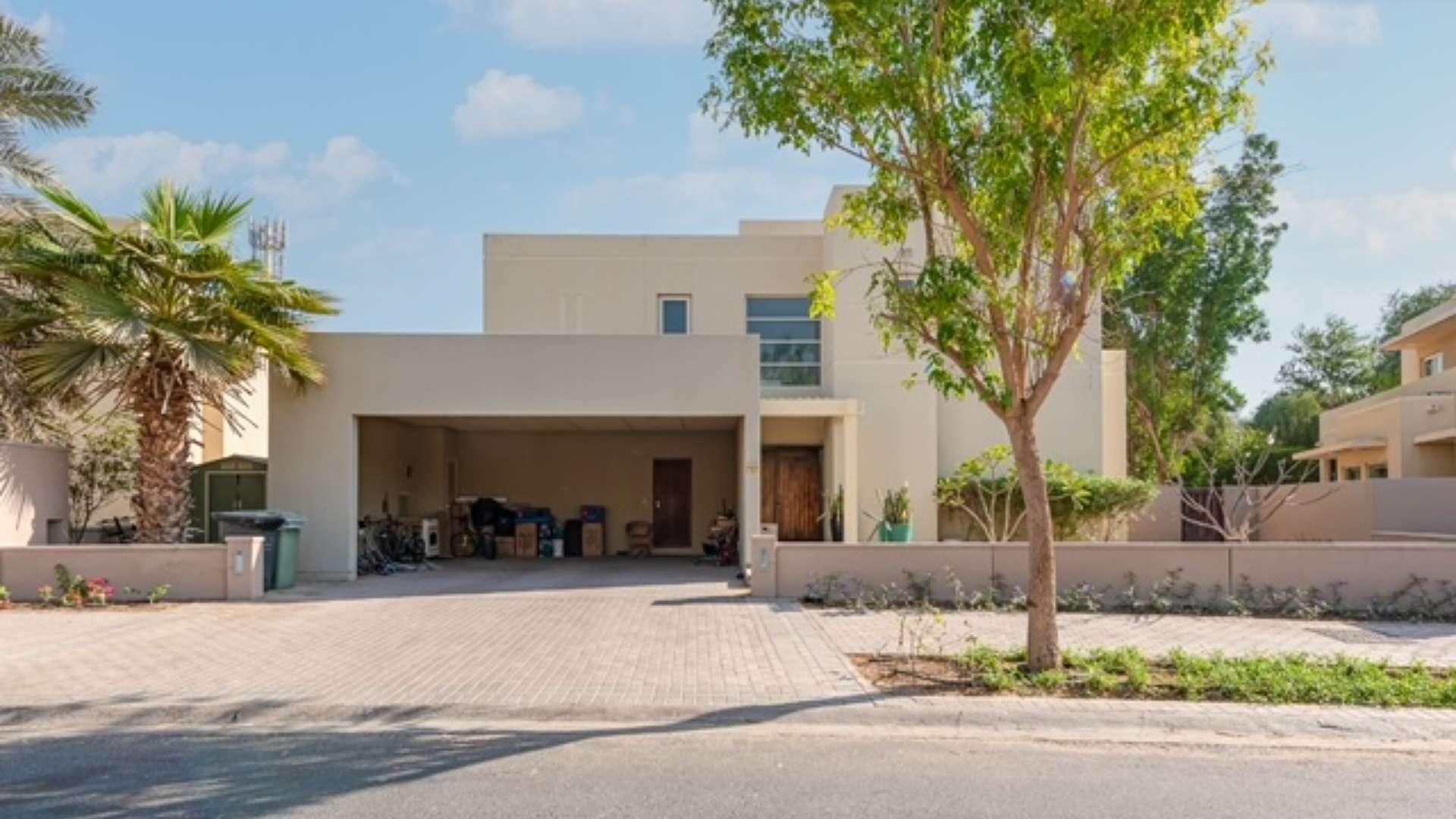 Spacious villa exterior in Saheel, Arabian Ranches with driveway and greenery, for sale