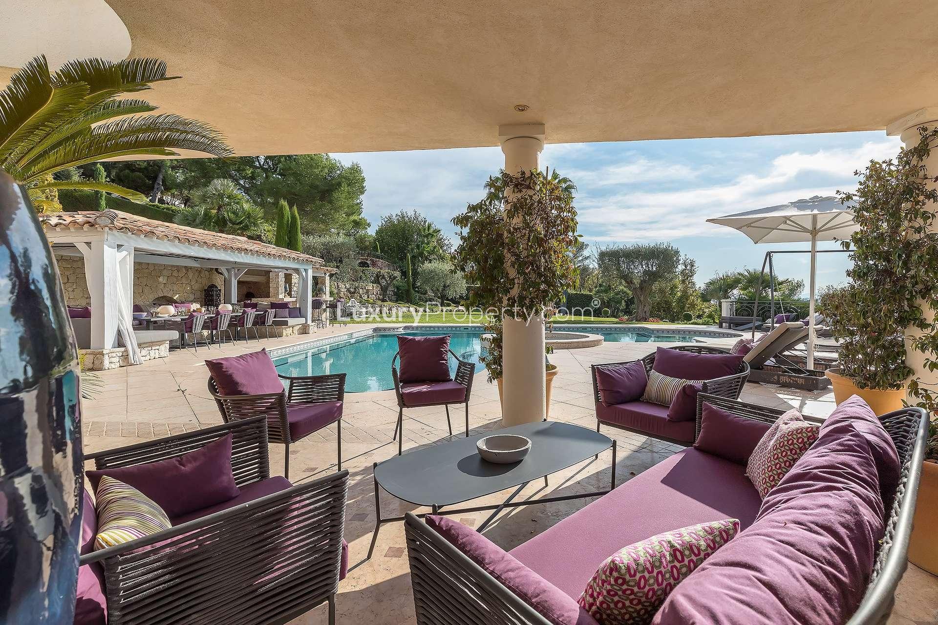 Luxurious walk-in closet with wooden cabinetry in St Paul de Vence villa for sale