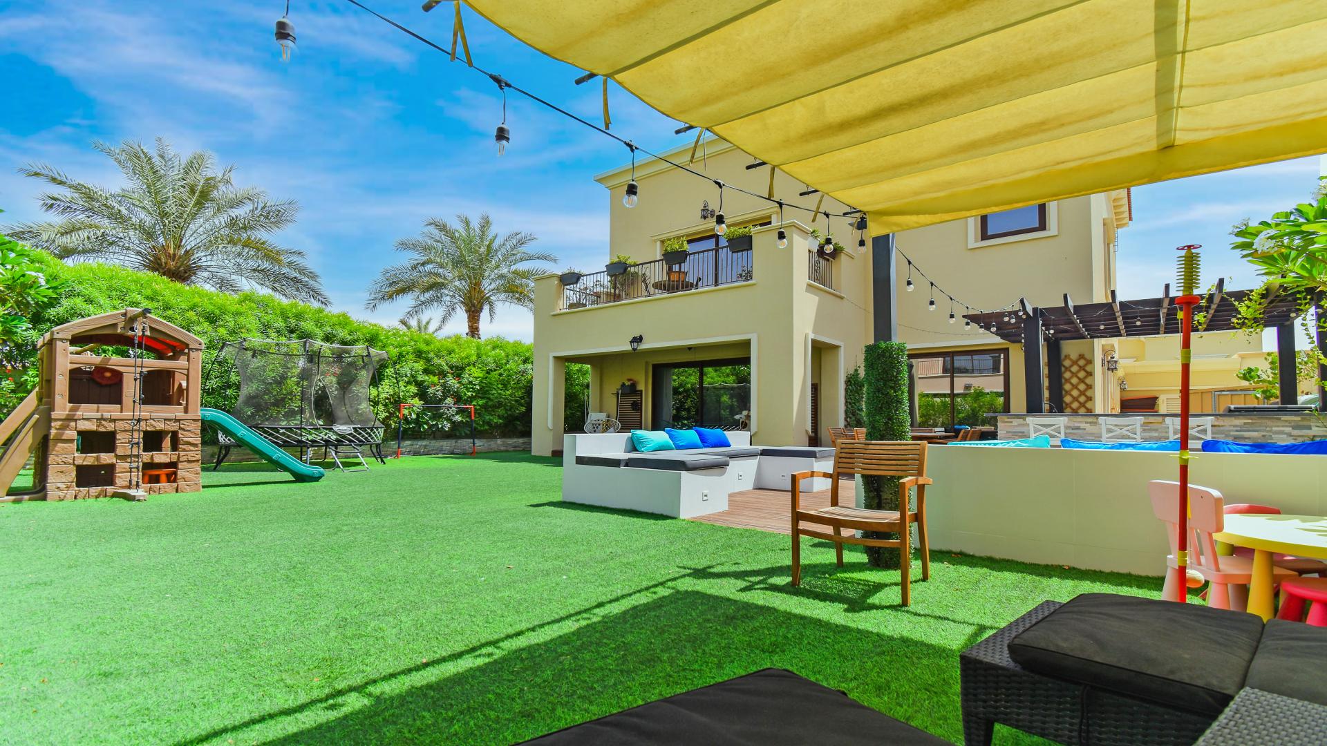 Outdoor patio with seating and bar in Samara villa, Arabian Ranches 2