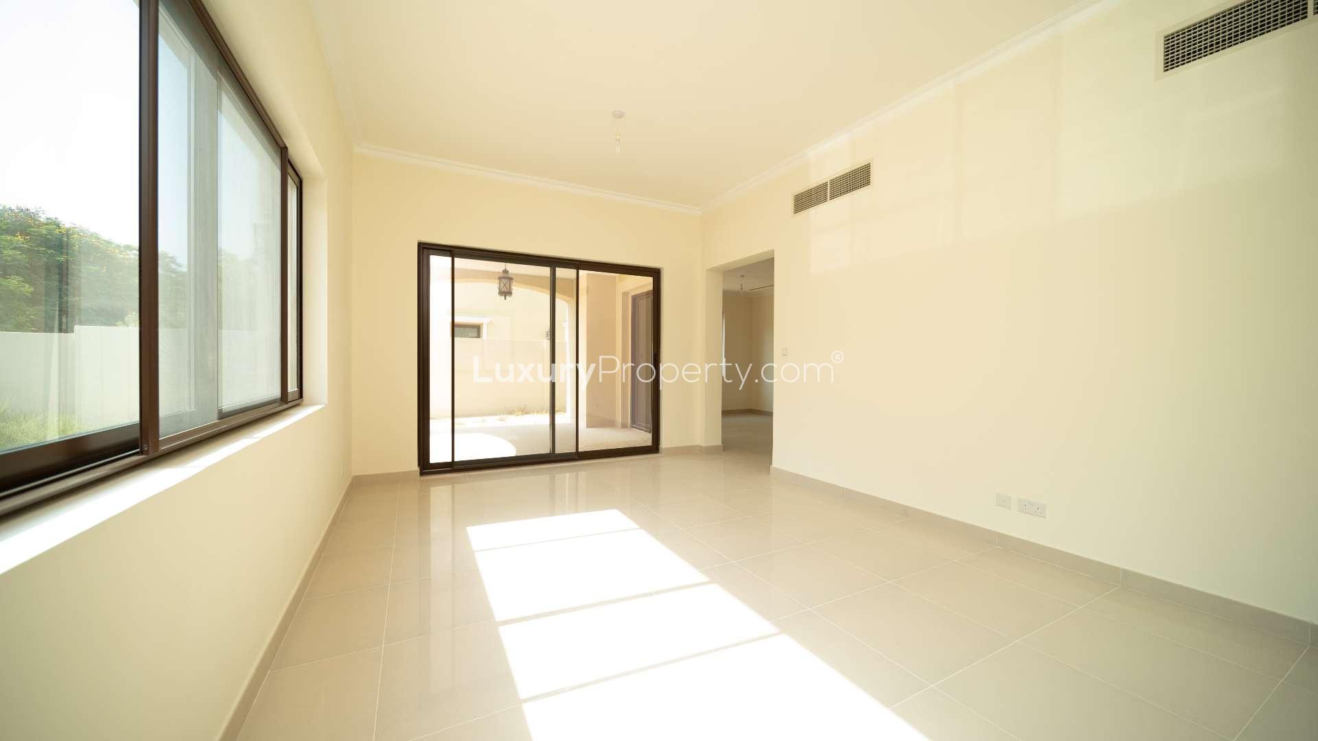 "View from Arabian Ranches Villa balcony overlooking lush landscape and residential street.",Bright living room in Arabian Ranches 2 Samara villa, featuring large windows and open space