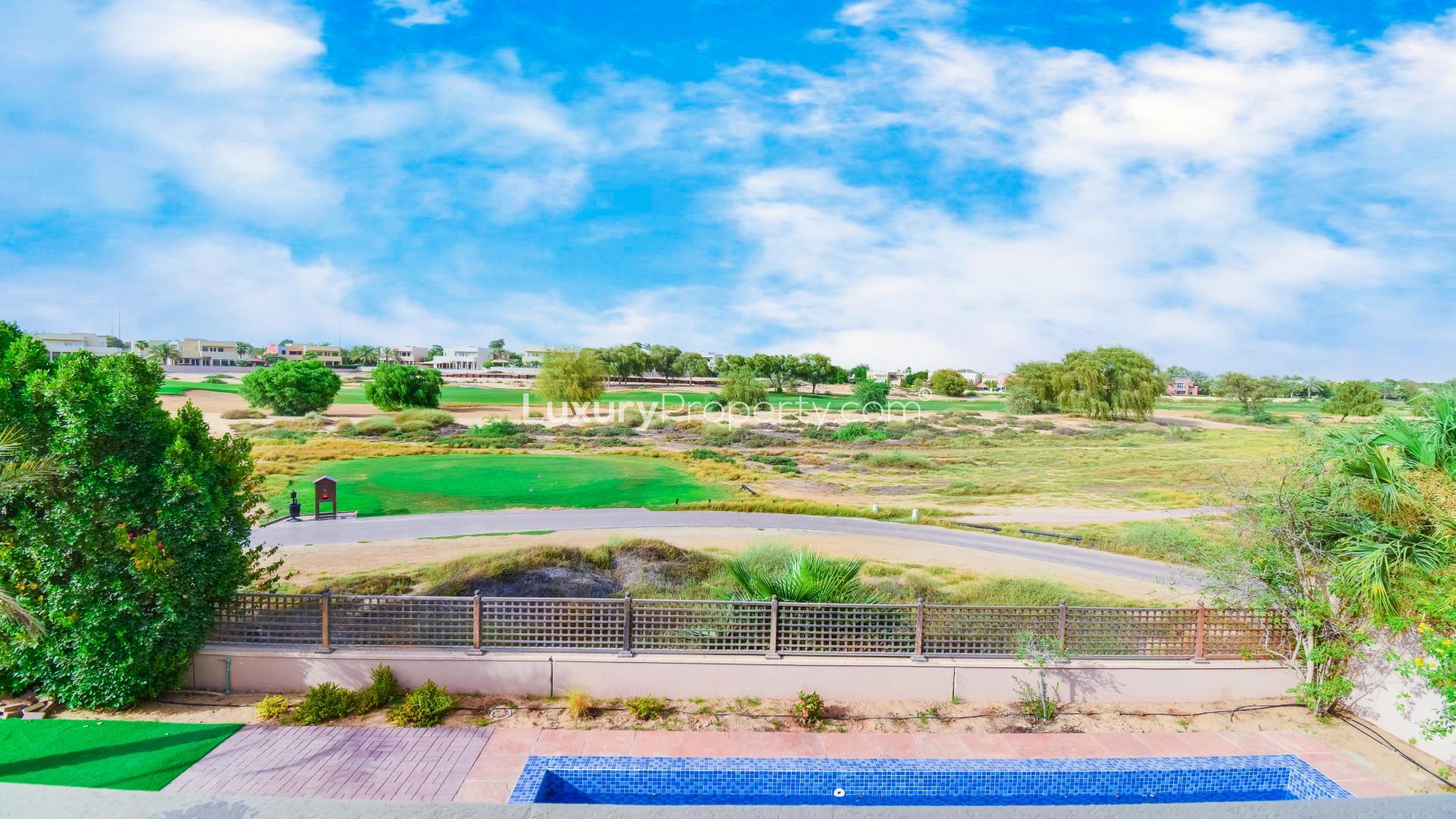 Stunning villa view with golf course, pool, and garden in Arabian Ranches Savannah