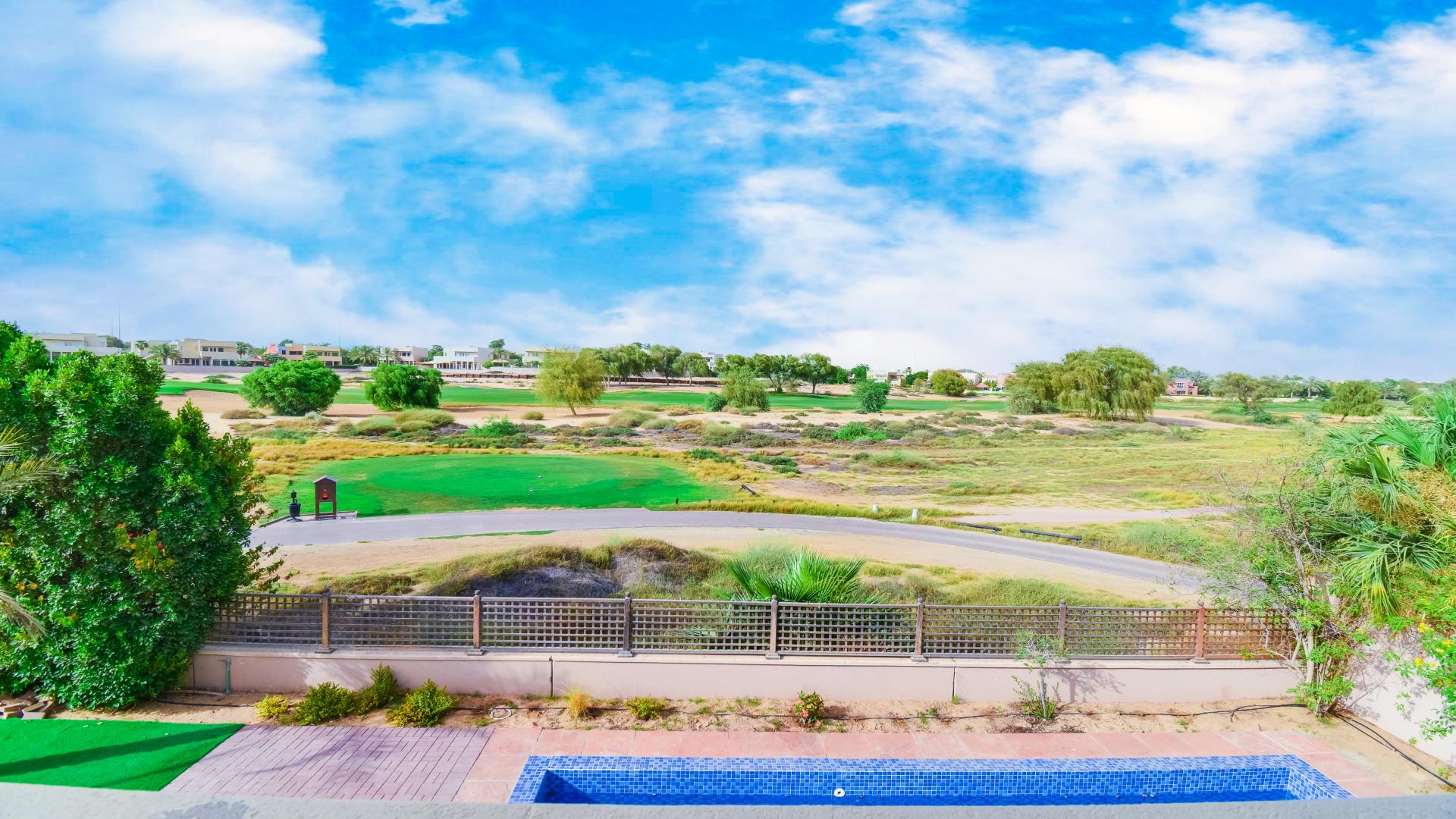 Stunning villa view with golf course, pool, and garden in Arabian Ranches Savannah