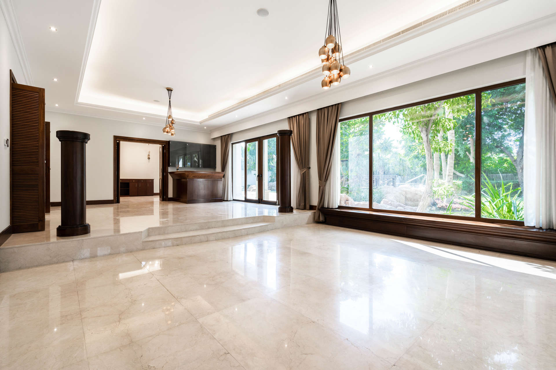 Spacious living room with large windows in Emirates Hills 5-bedroom villa for rent