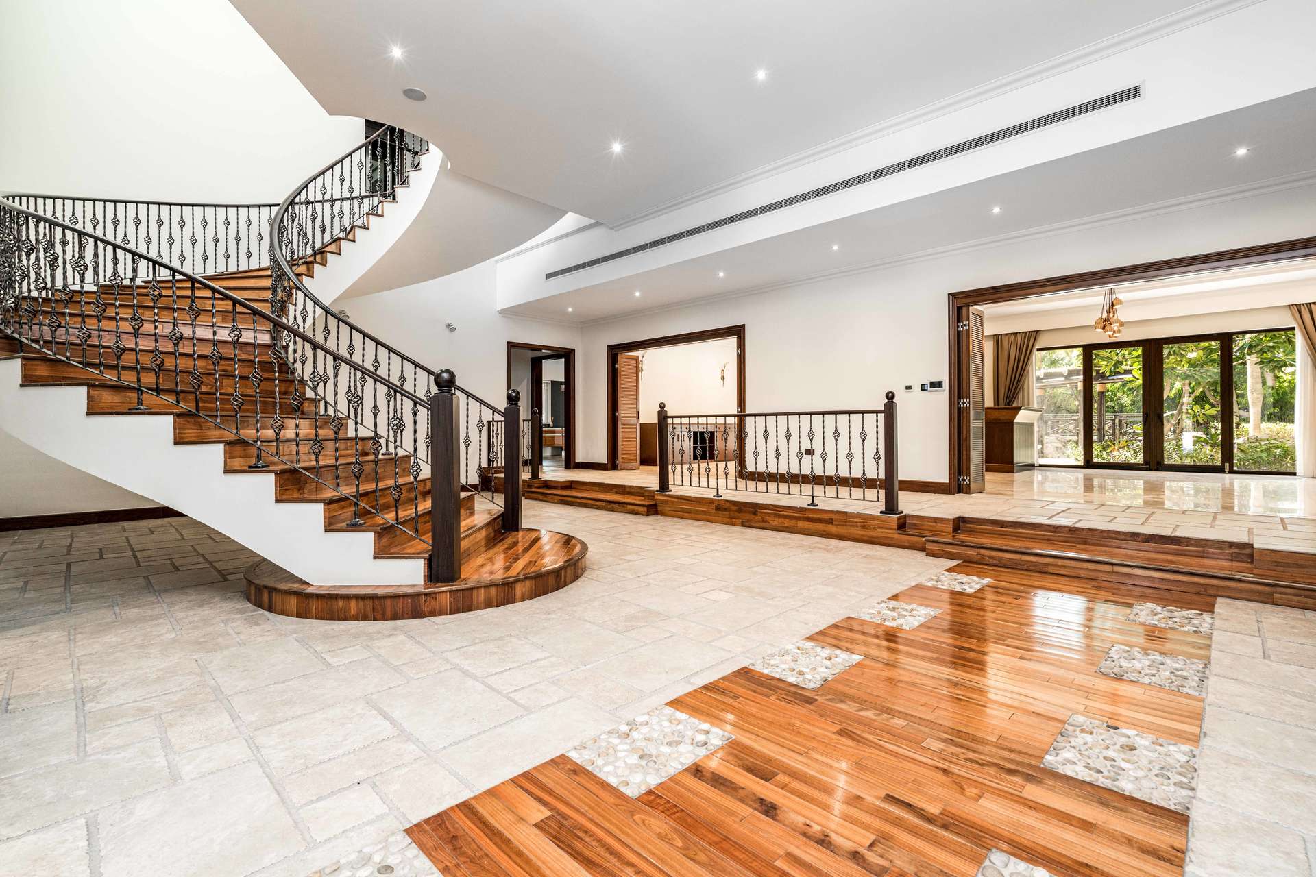 Impressive 5-bedroom villa exterior in Emirates Hills, Dubai, with lush garden and patio