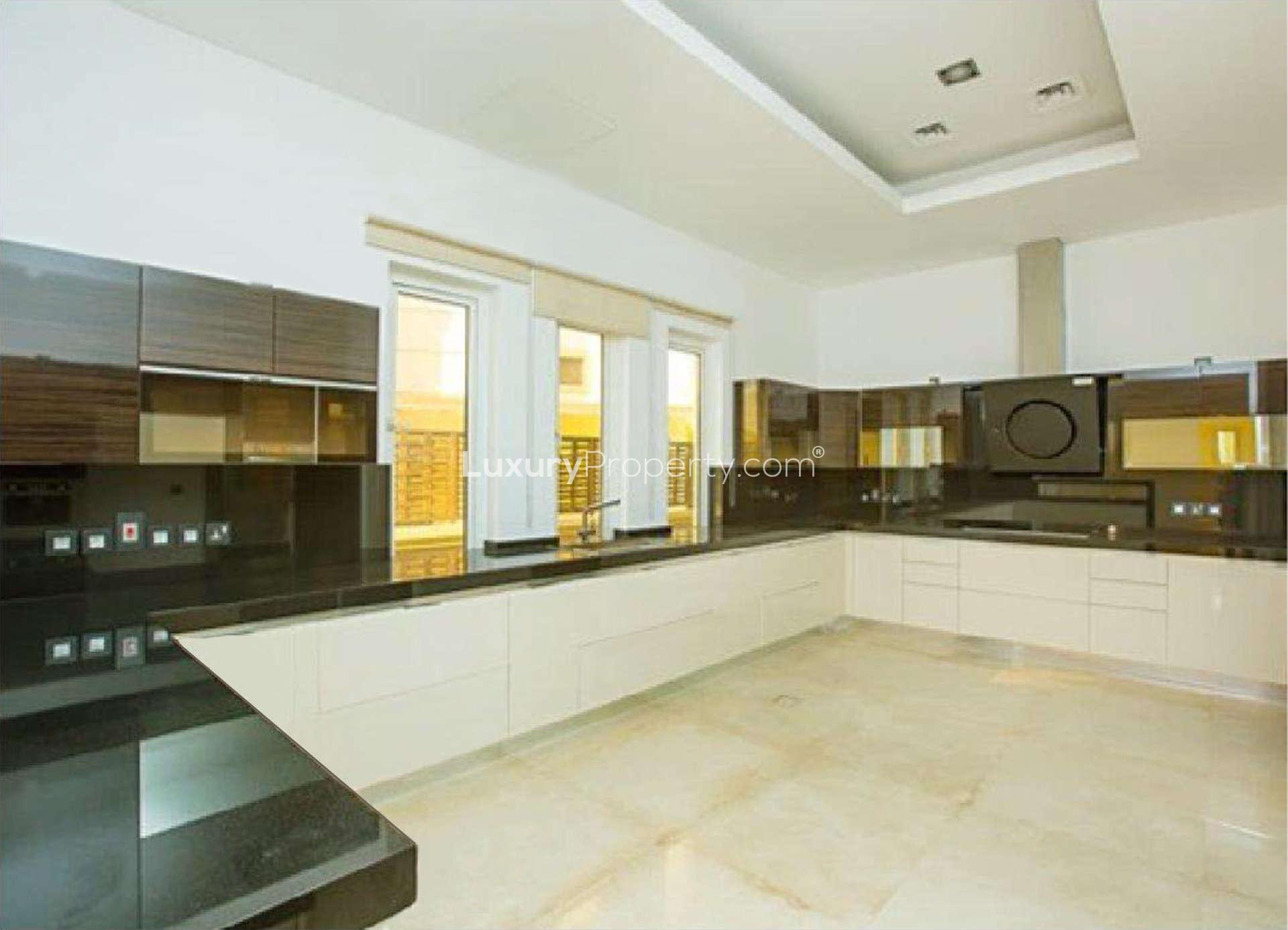 Spacious living room with large windows in luxury Emirates Hills villa, Sector P