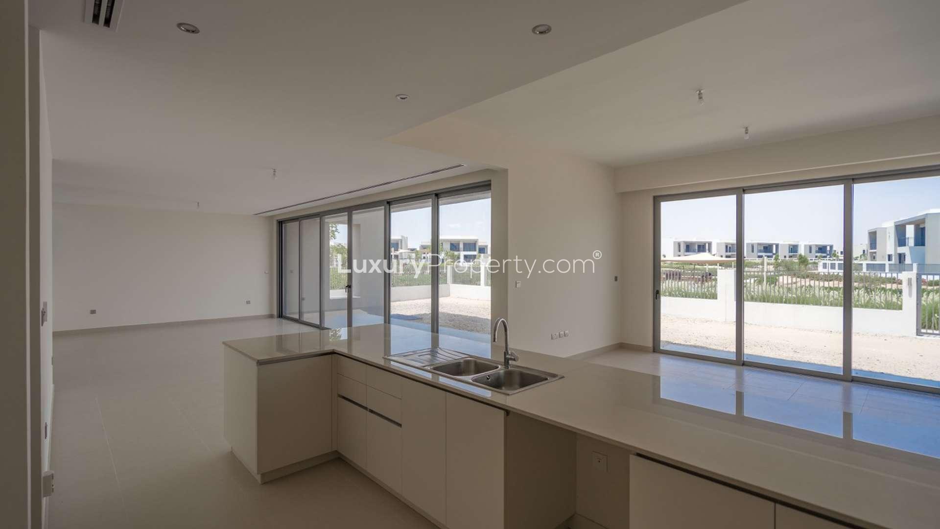 Modern kitchen in Sidra Villas, Dubai Hills Estate, featuring sleek cabinetry and open layout