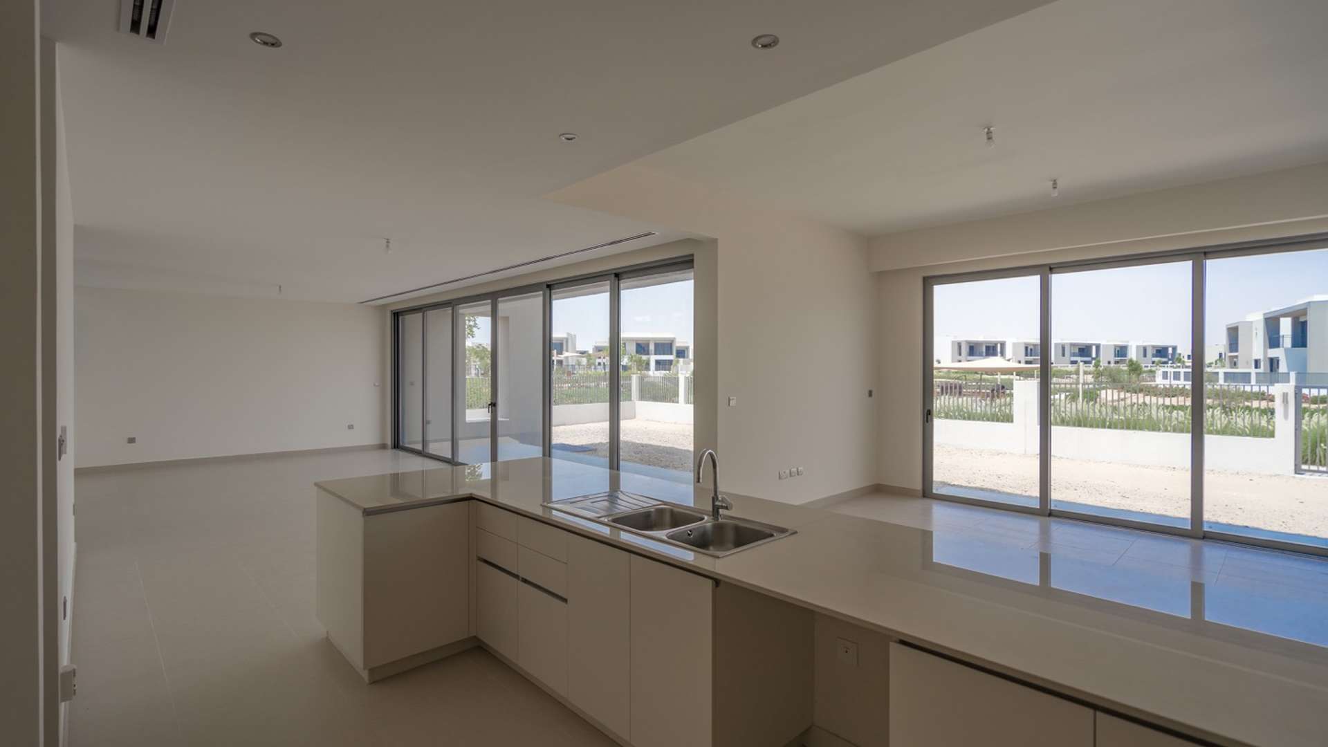 Modern kitchen in Sidra Villas, Dubai Hills Estate, featuring sleek cabinetry and open layout