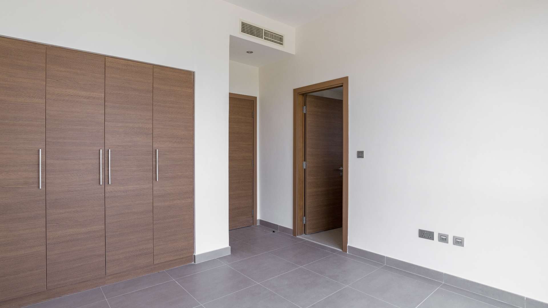 Empty room in luxurious Sidra Villa, Dubai Hills Estate, featuring modern finishes and natural light