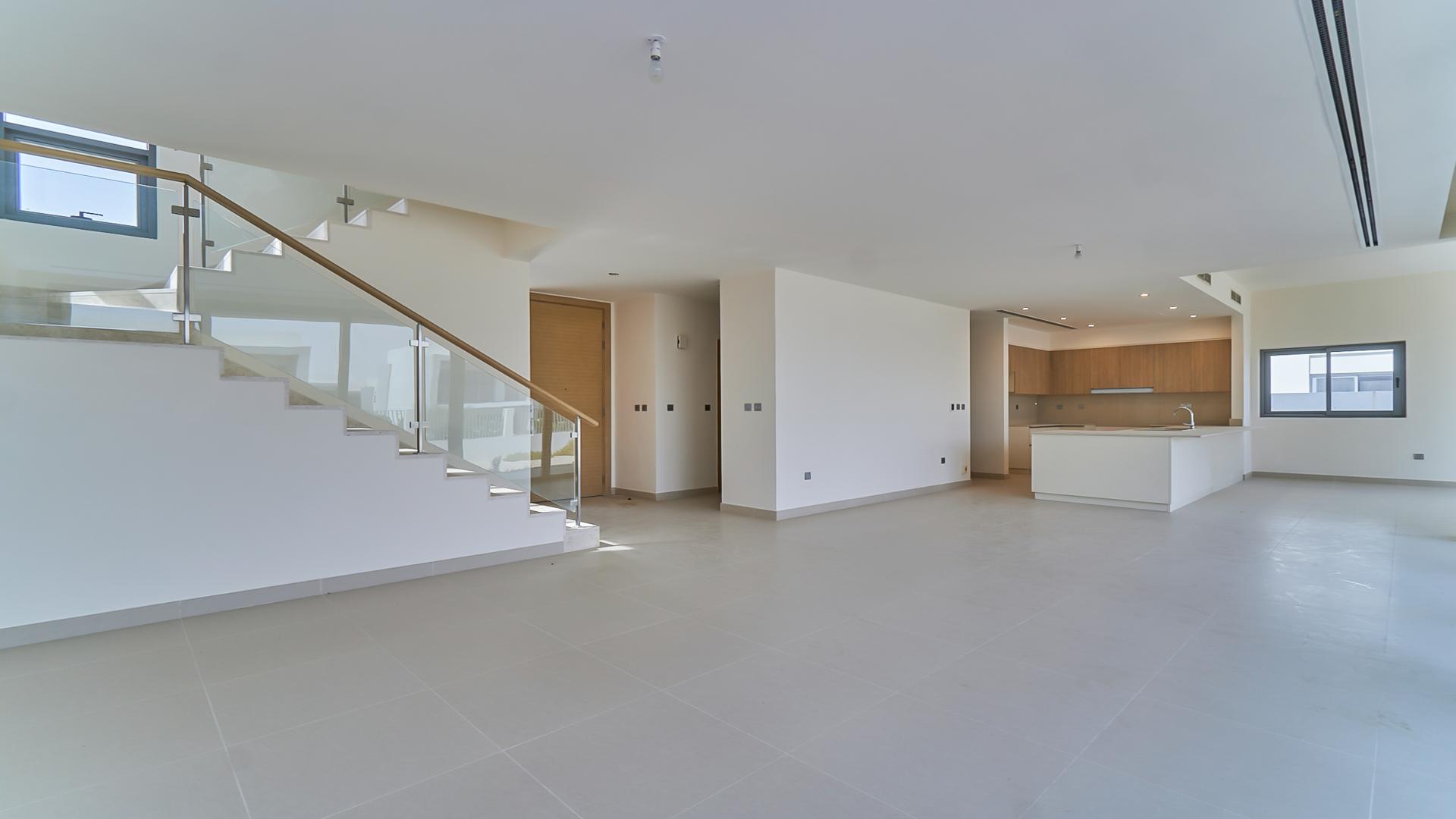 Empty living room with large windows in Dubai Hills Estate villa for sale