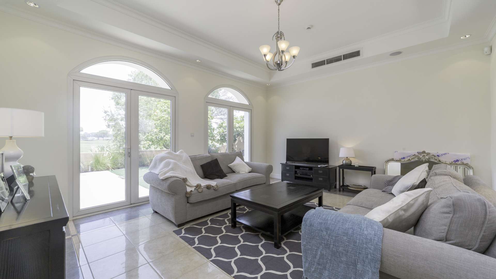 Luxurious living room in Sienna Lakes villa, Jumeirah Golf Estates, overlooking garden