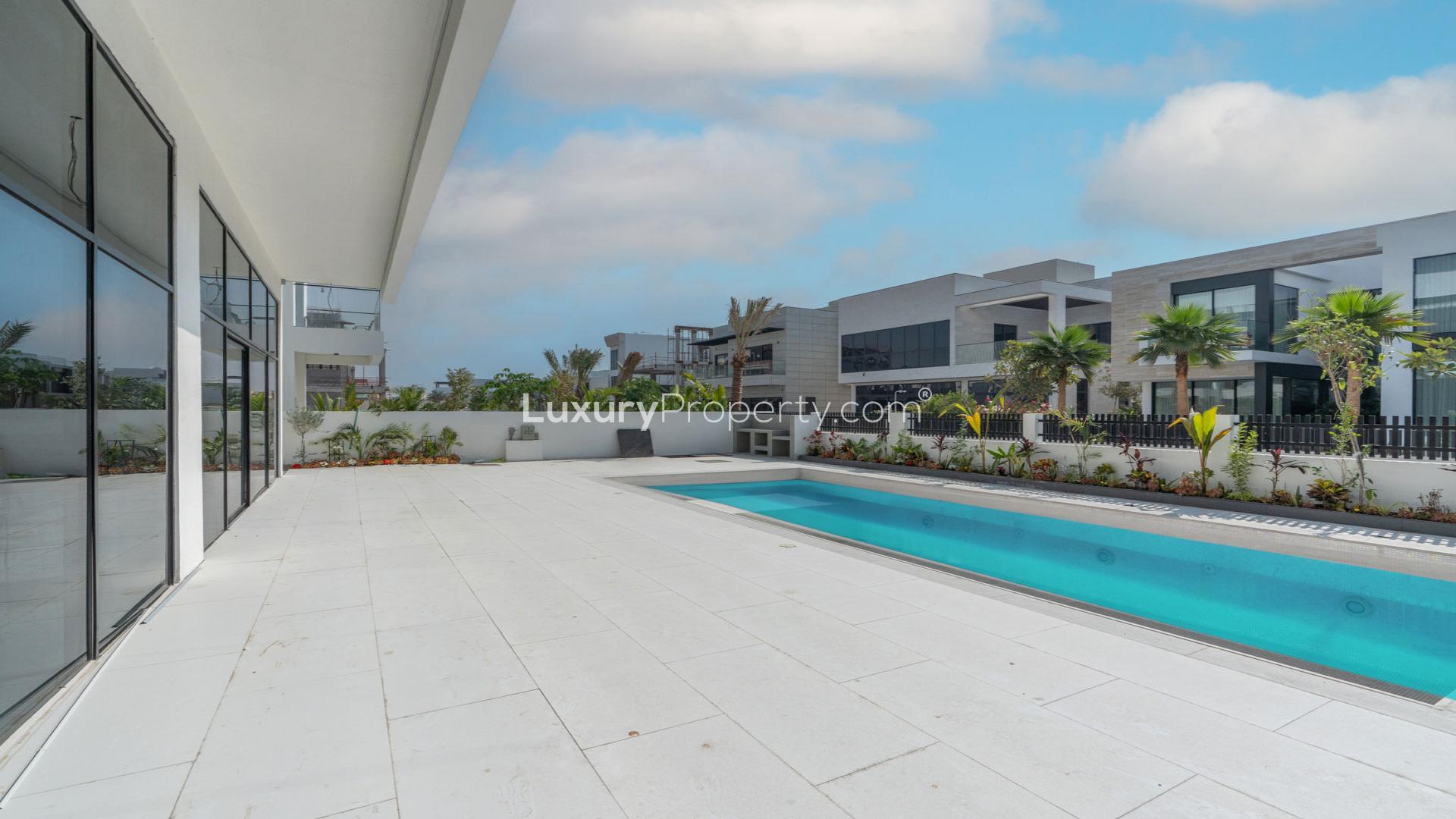 Luxurious villa interior with marble floors, modern staircase, and large windows in Jumeirah Park