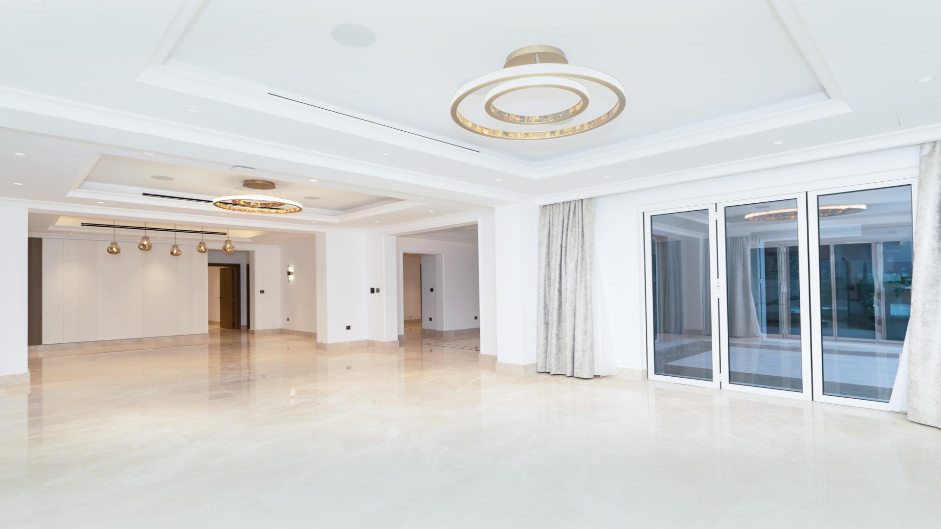 Spacious living room with modern chandelier in Mirador La Coleccion villa, Arabian Ranches 1