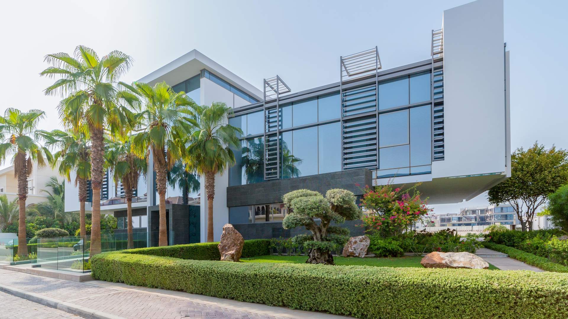 Ultra-luxury beachfront villa exterior with palm trees, Palm Jumeirah, Signature Villas