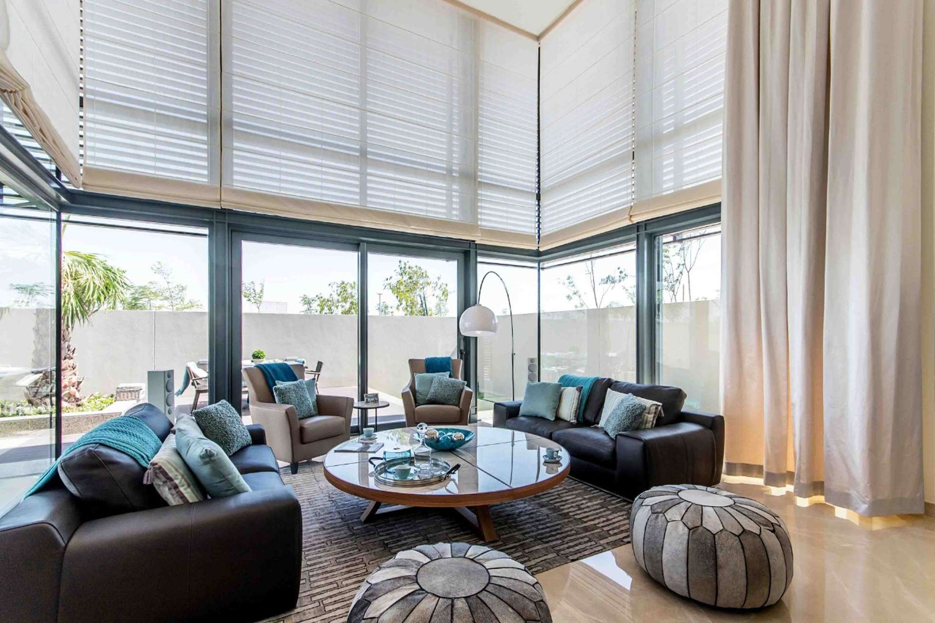 Luxurious living room in Sobha Hartland villa with modern furnishings and large windows