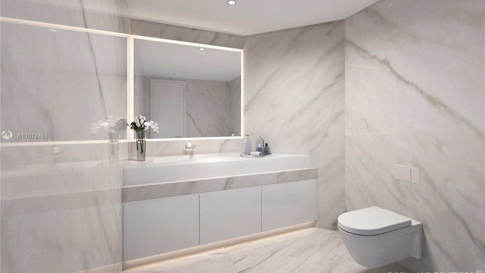 Luxurious kitchen in waterfront villa, Sunny Isles Beach, featuring modern design and marble accents