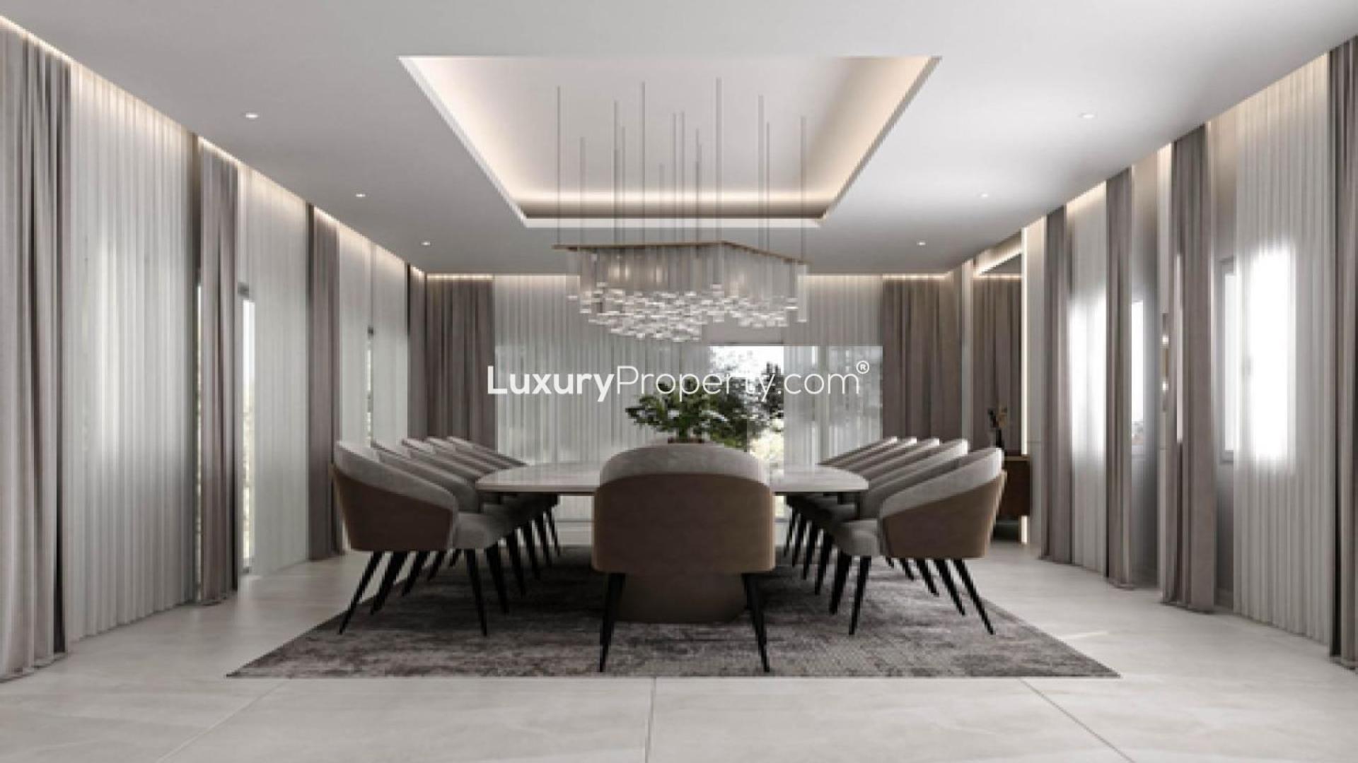 Luxurious Asora Bay waterfront villa exterior at twilight, featuring modern architecture and palm trees