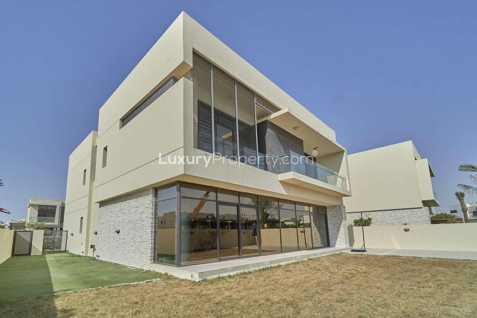 Luxurious living room in 5-bedroom villa, Damac Hills 2, featuring modern decor and garden view