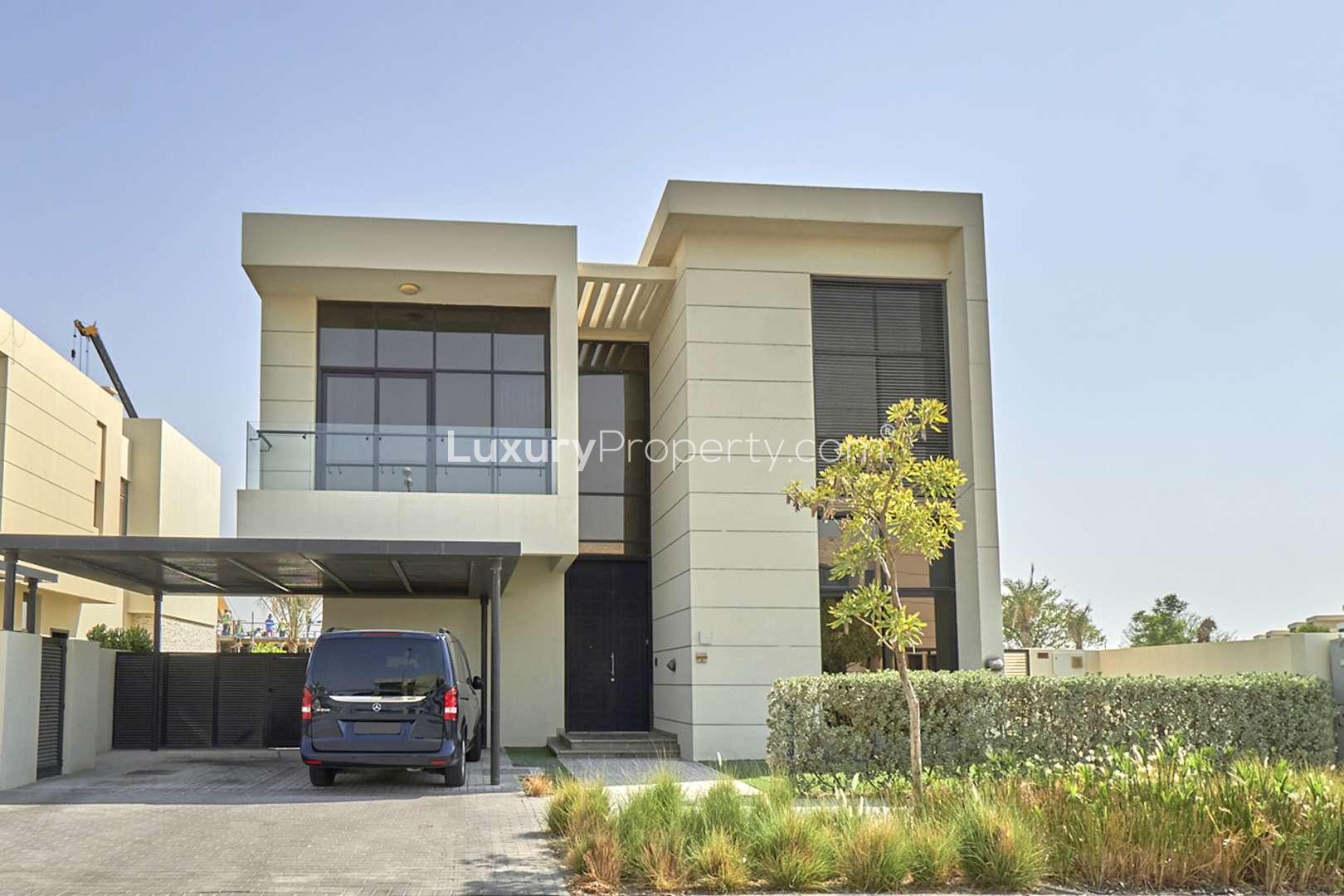 Luxurious living room in 5-bedroom villa, Damac Hills 2, featuring plush seating and decor