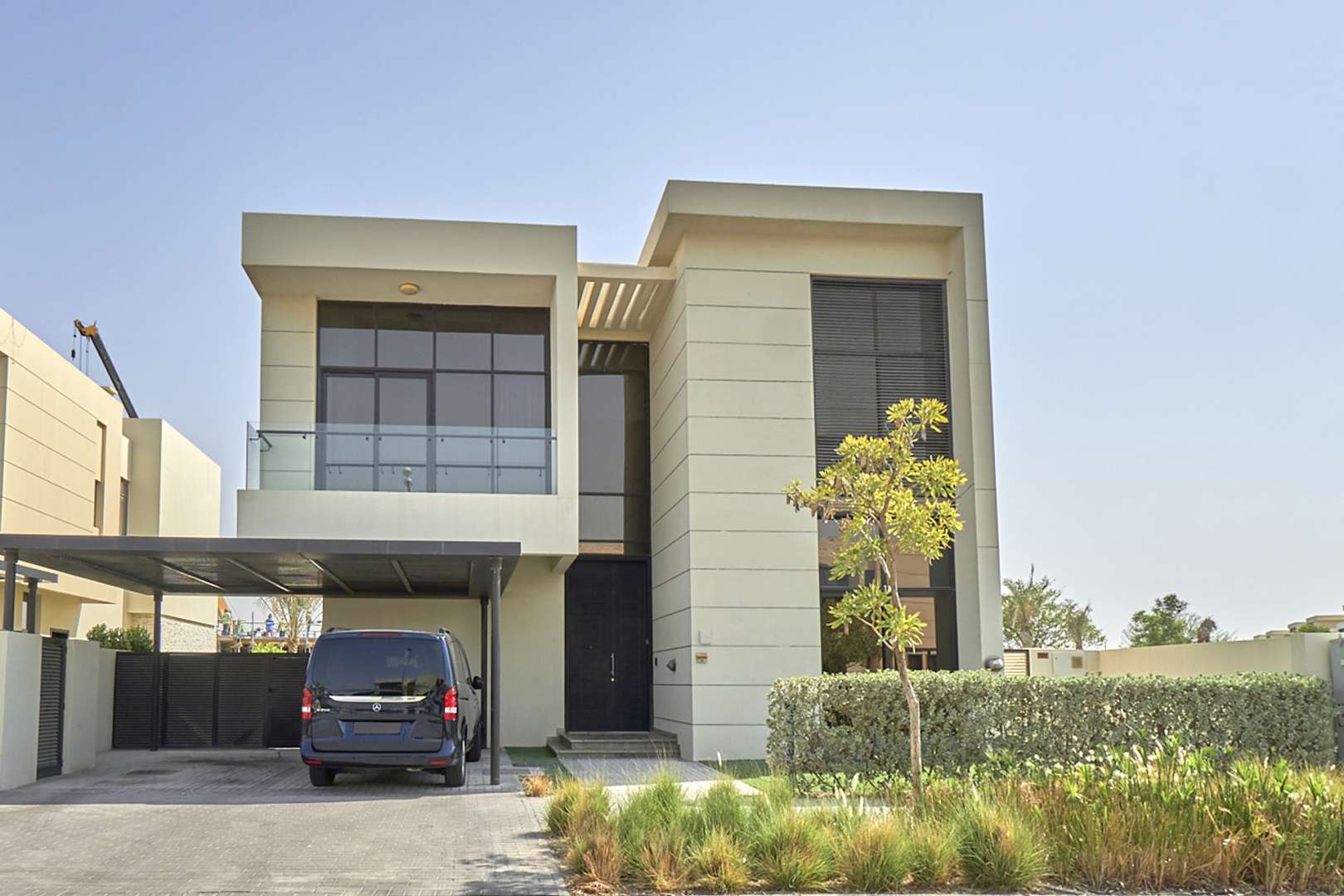 Luxurious living room in 5-bedroom villa, Damac Hills 2, featuring plush seating and decor